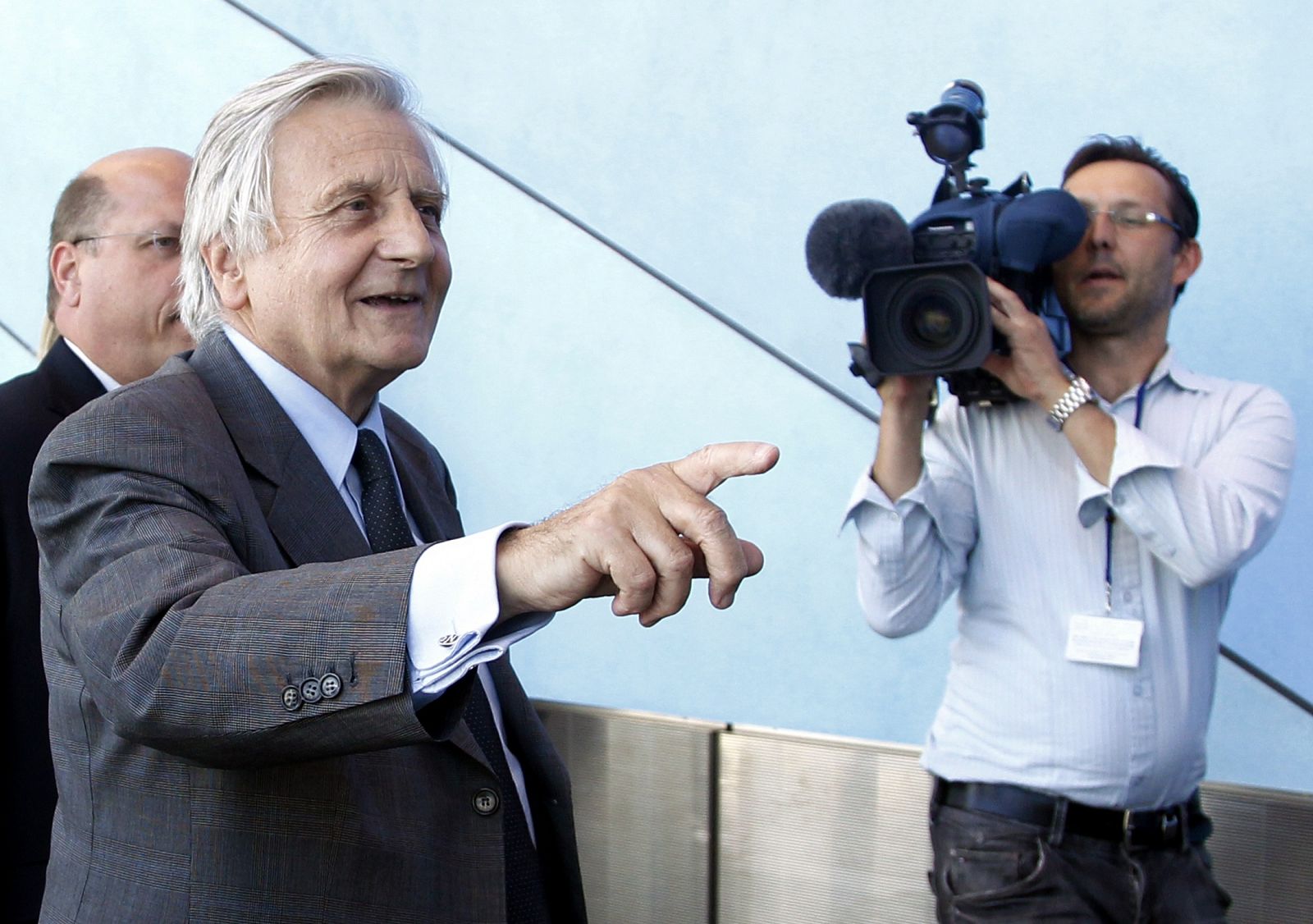 Jean-Claude Trichet gestures as he leaves a debate in Brussels