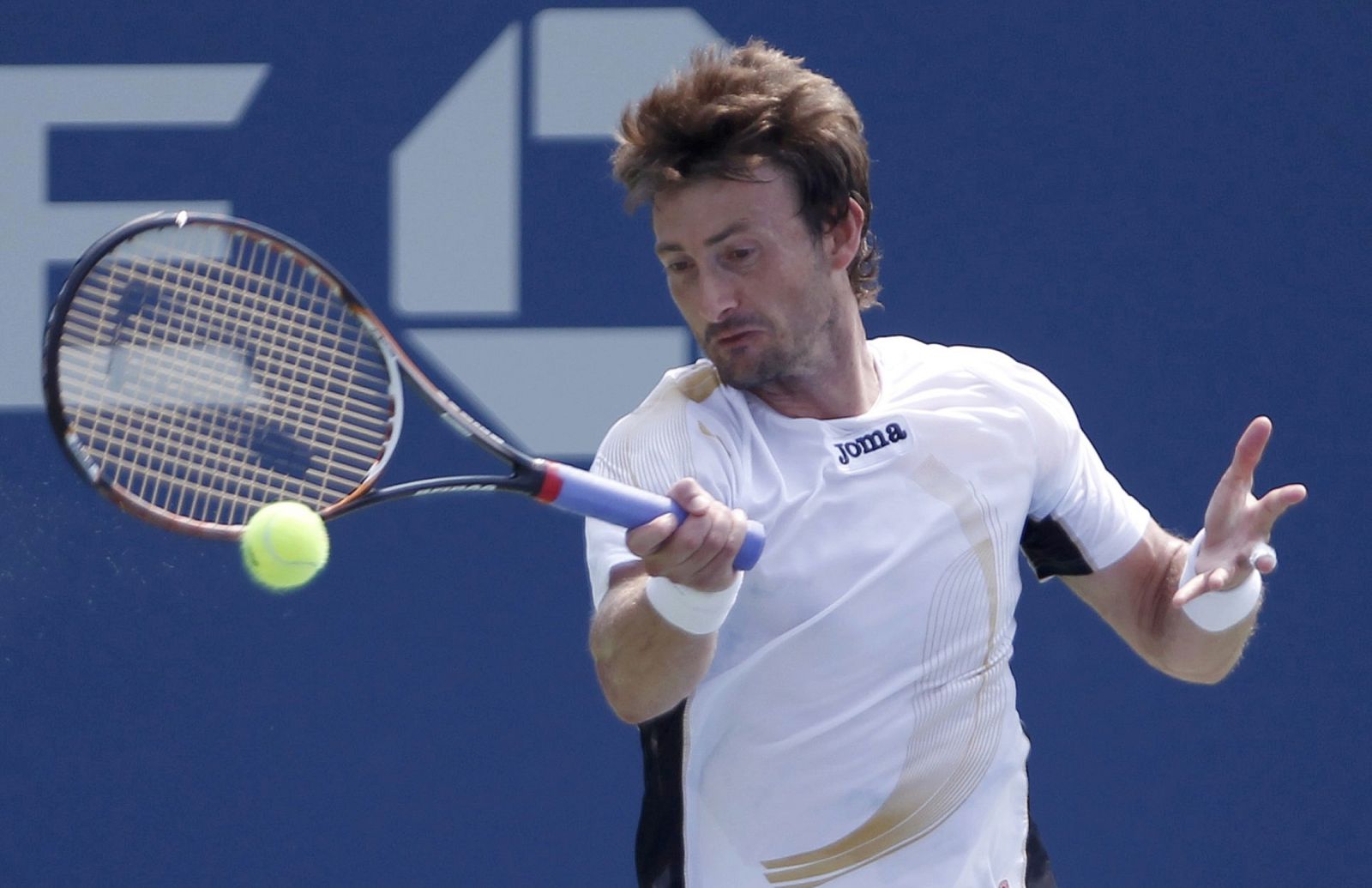 Juan Carlos Ferrero of Spain hits a return to compatriot Marcel Granollers during their match at the U.S. Open tennis tournament in New York