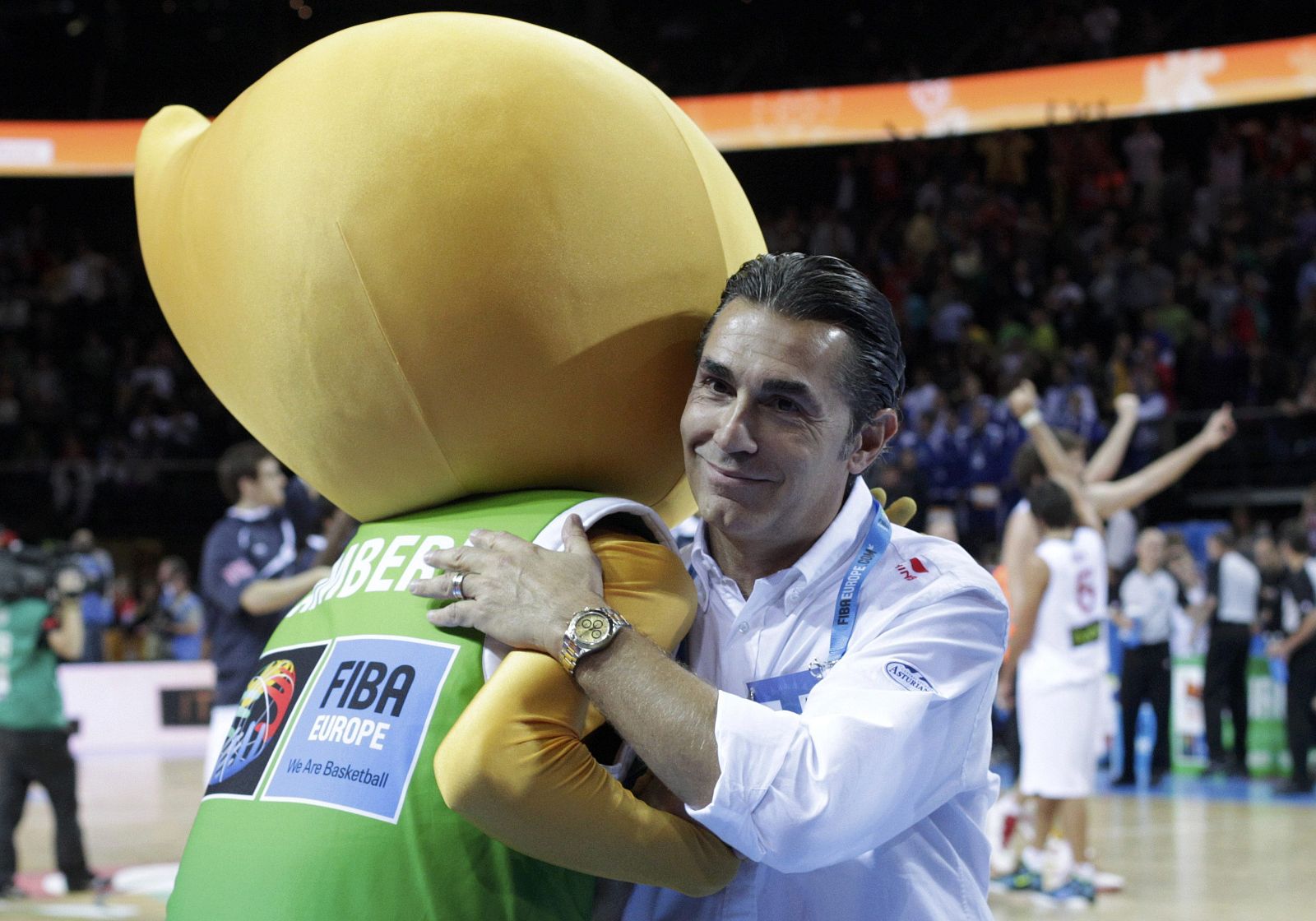 Spain's coach Scariolo hugs the mascot of the FIBA EuroBasket 2011 after the end of his teams' semi-final basketball game against Macedonia in Kaunas