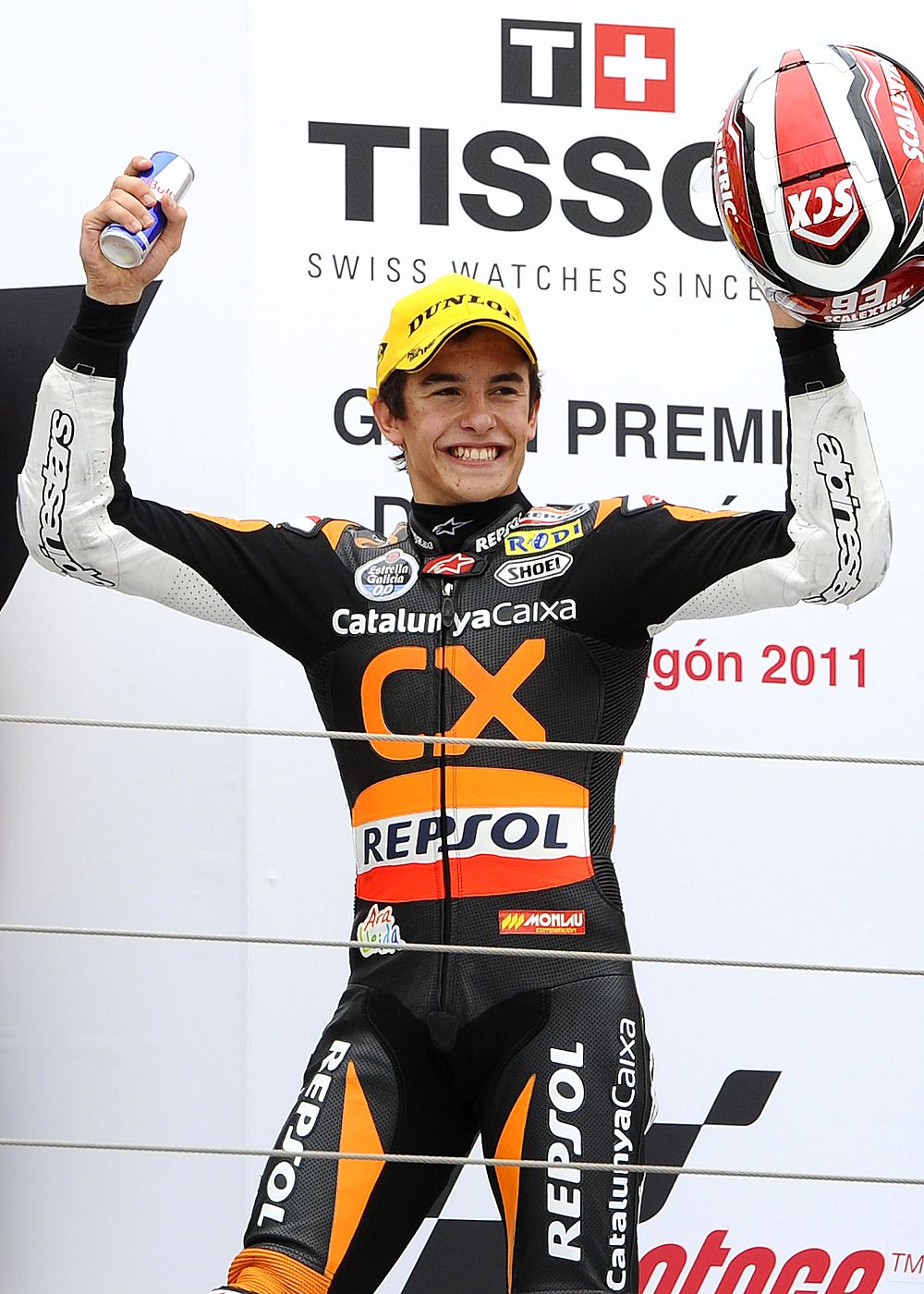 Suter Moto2 rider Marc Marquez of Spain raises his helmet on the podium after winning during the Aragon Grand Prix at Motorland racetrack in Alcaniz