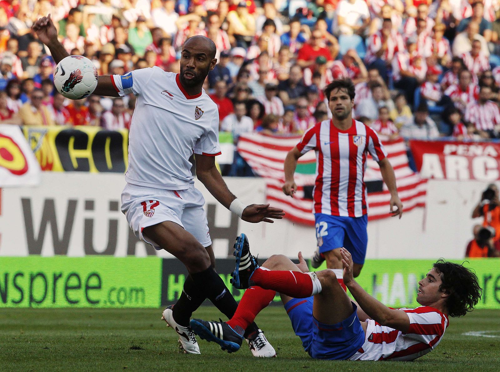 Atletico Madrid's Tiago fights for the ball with Sevilla's Kanoute during their Spanish First Division soccer match in Madrid