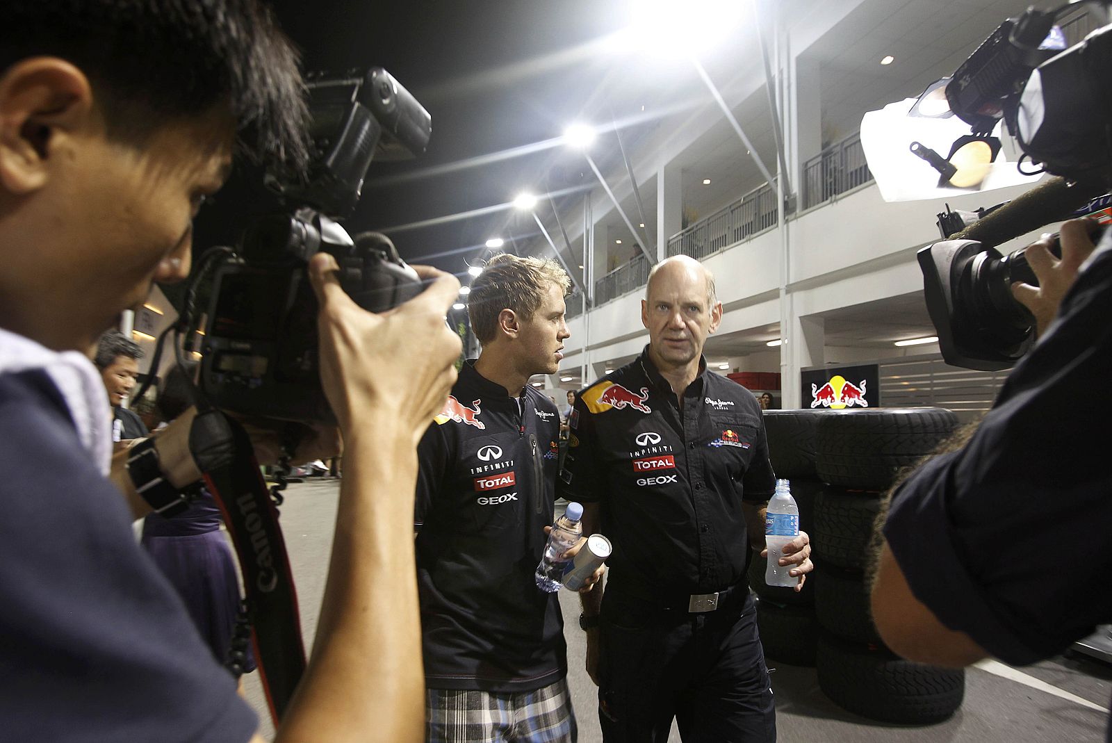 Race winner Red Bull Formula One driver Vettel speaks with Red Bull technical chief Newey after the Singapore F1 Grand Prix
