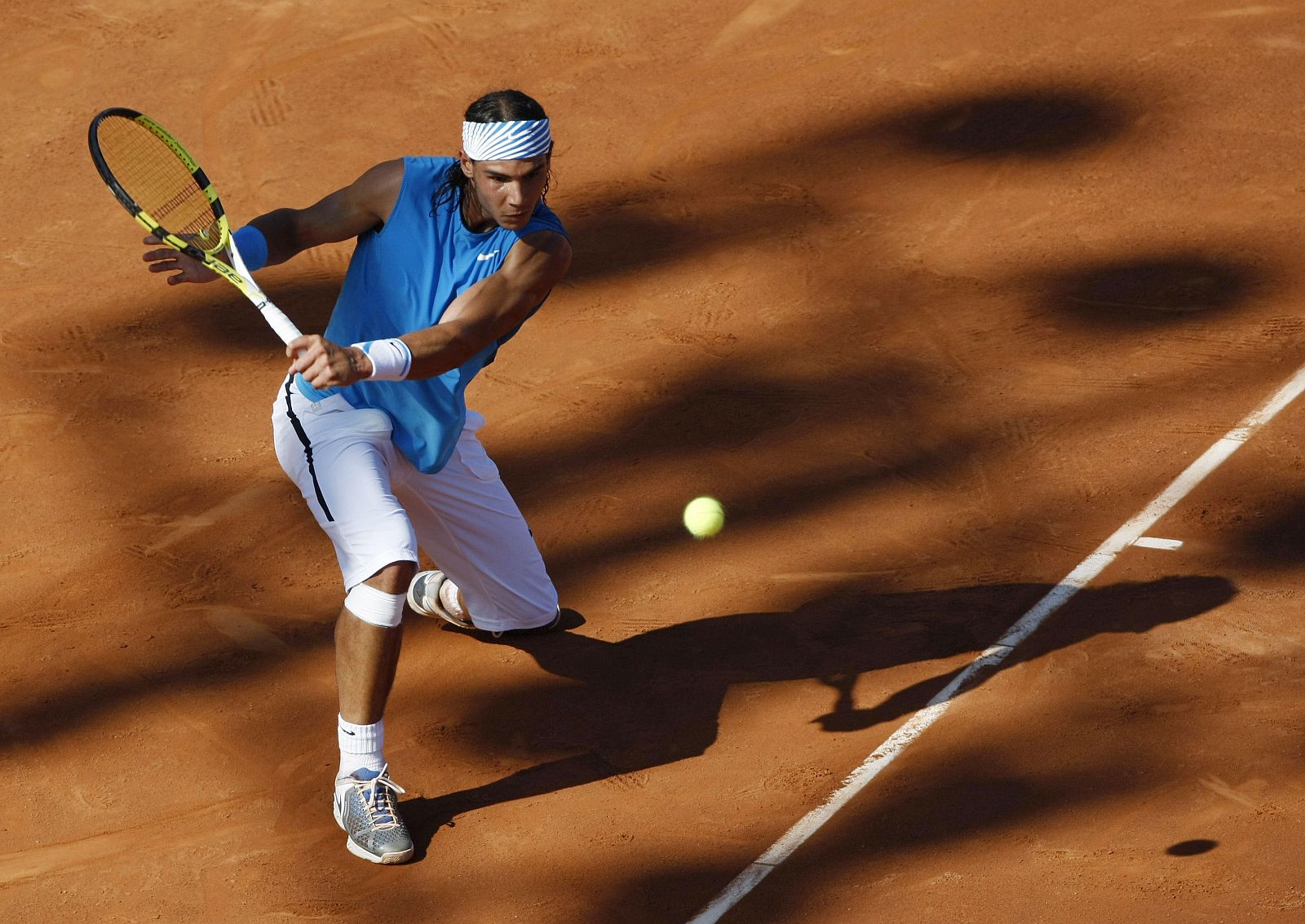 Rafael Nadal of Spain returns a ball to compatriot David Ferrer during their final match at the Barcelona Open tennis tournament