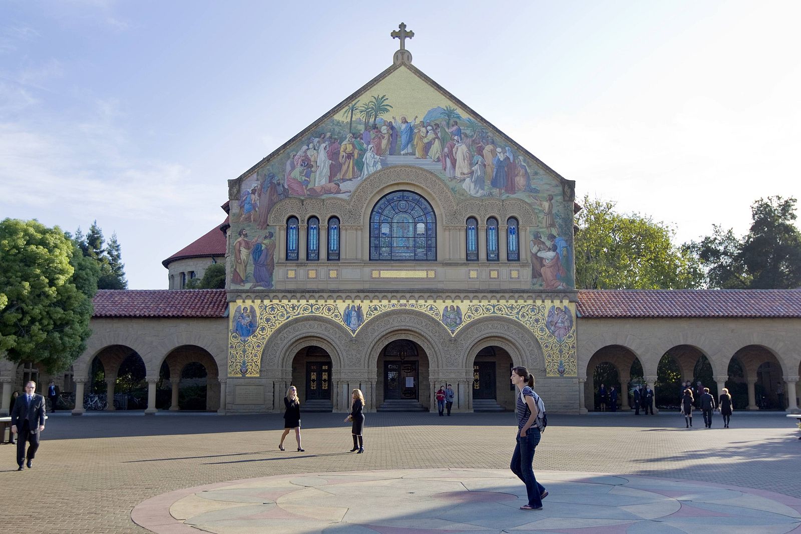 People walk in front of a church on the campus of Stanford University in Palo Alto