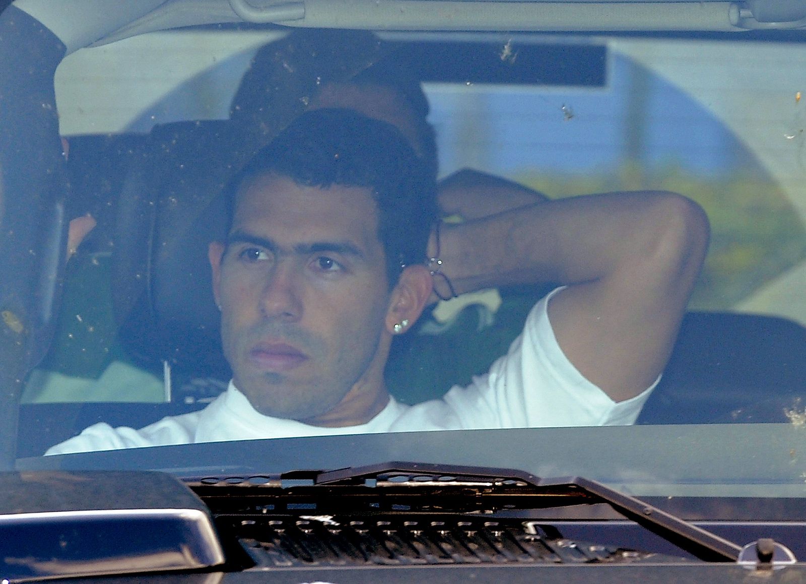 Manchester City's soccer player Carlos Tevez of Argentina is driven from the club's training complex at Carrington in Manchester, northern England