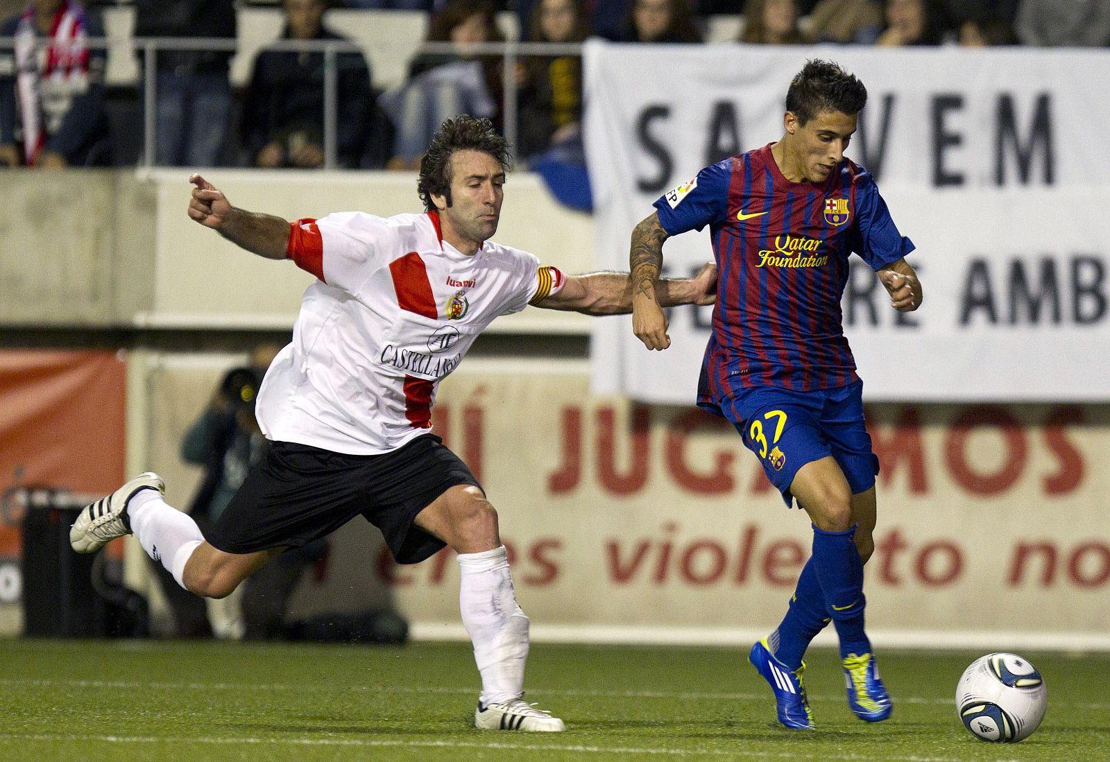 El delantero Tello (d) intenta avanzar con el balón ante la presión del defensor del L'Hospitalet, Albert Vela.