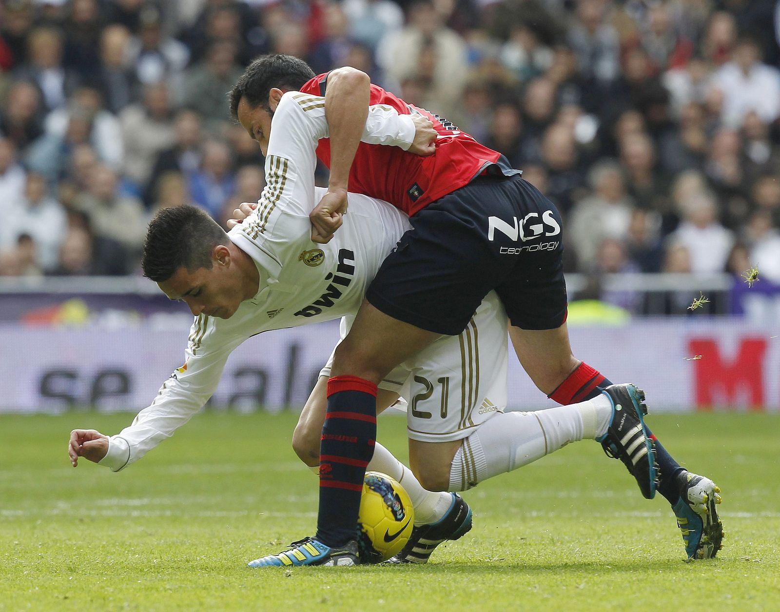 Real Madrid's Callejon fights for the ball with Osasuna's Calleja during their Spanish First Division soccer match in Madrid