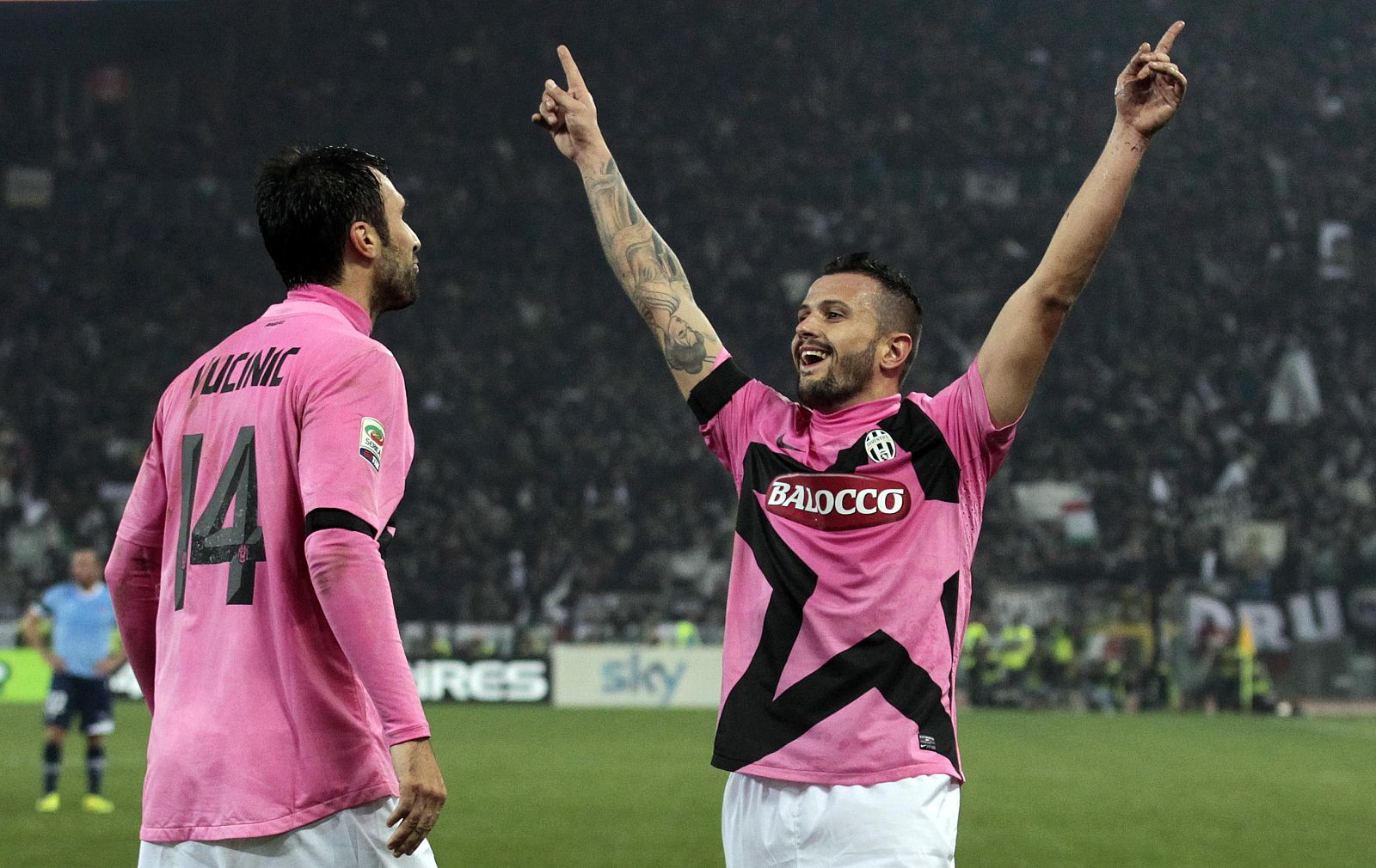 Juventus' Simone Pepe celebrates with teammate Mirko Vucinic after scoring against Lazio during their Serie A soccer match at the Olympic stadium in Rome