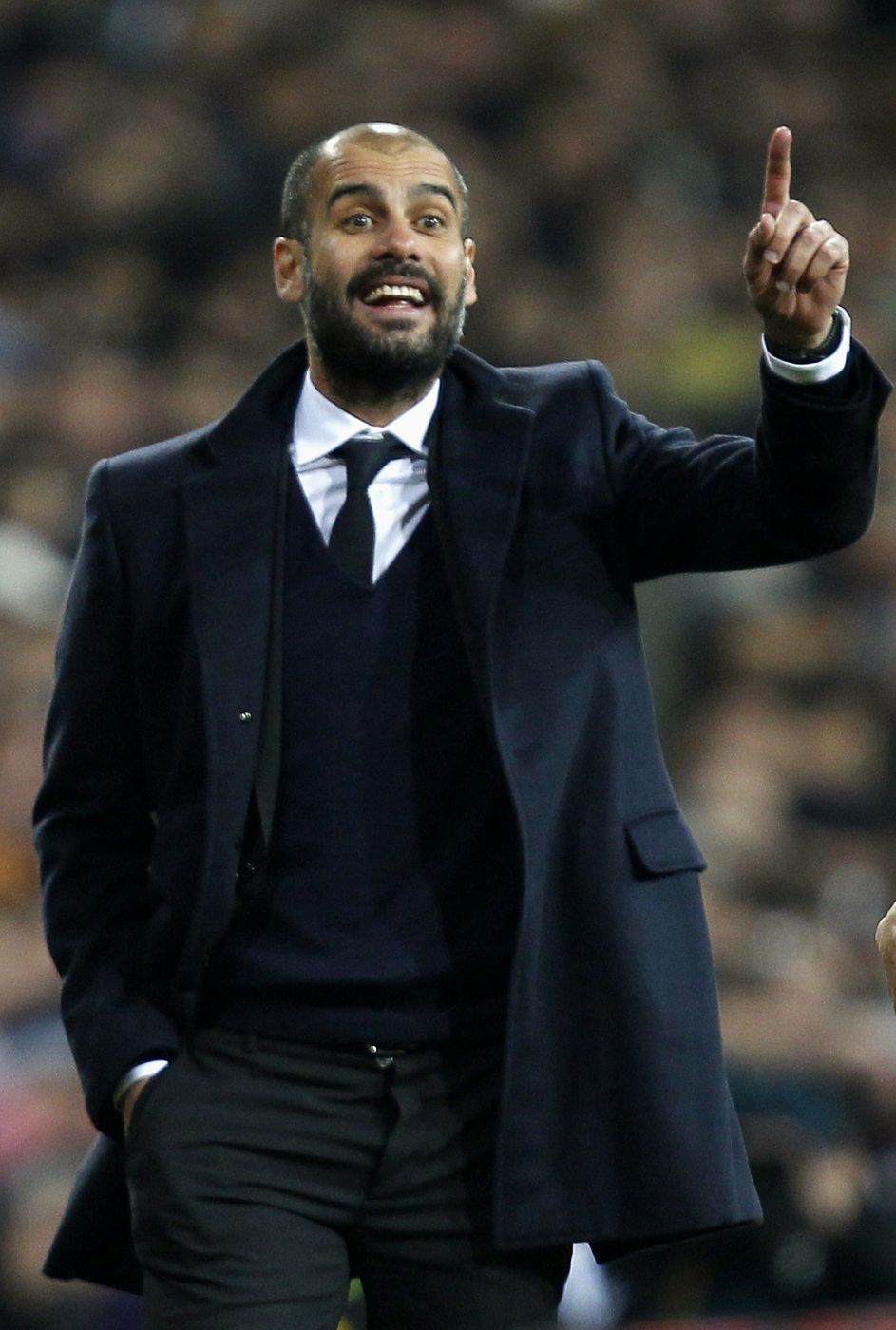 Barcelona's coach Pep Guardiola celebrates Xavi Hernandez goal against Real Madrid during their Spanish first division soccer match, the "Clasico", against Barcelona at the Santiago Bernabeu stadium in Madrid