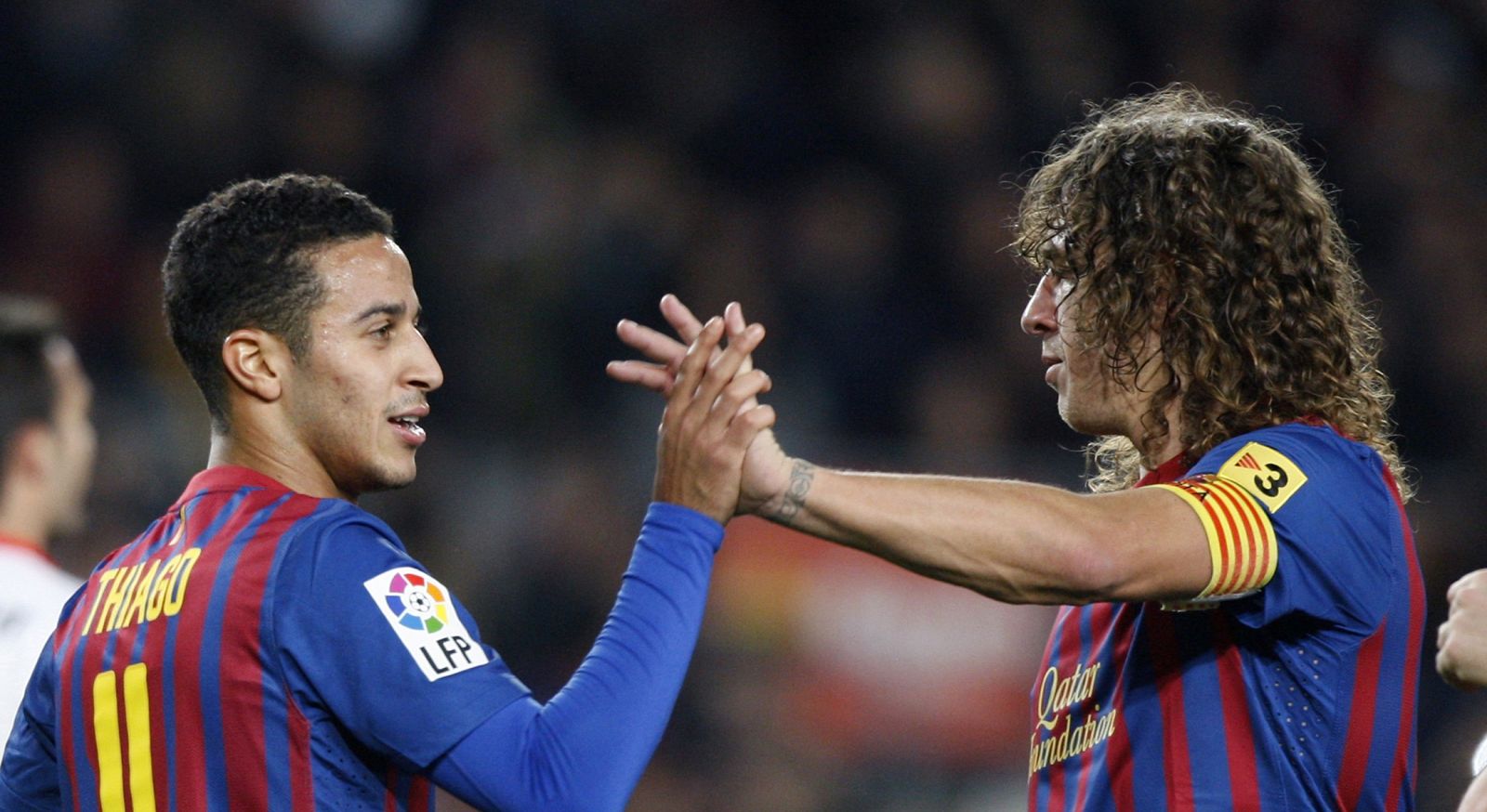 Barcelona's Thiago Alcantara celebrates a goal with captain Carles Puyol during their Spanish King's Cup soccer match against Hospitalet at Camp Nou stadium in Barcelona
