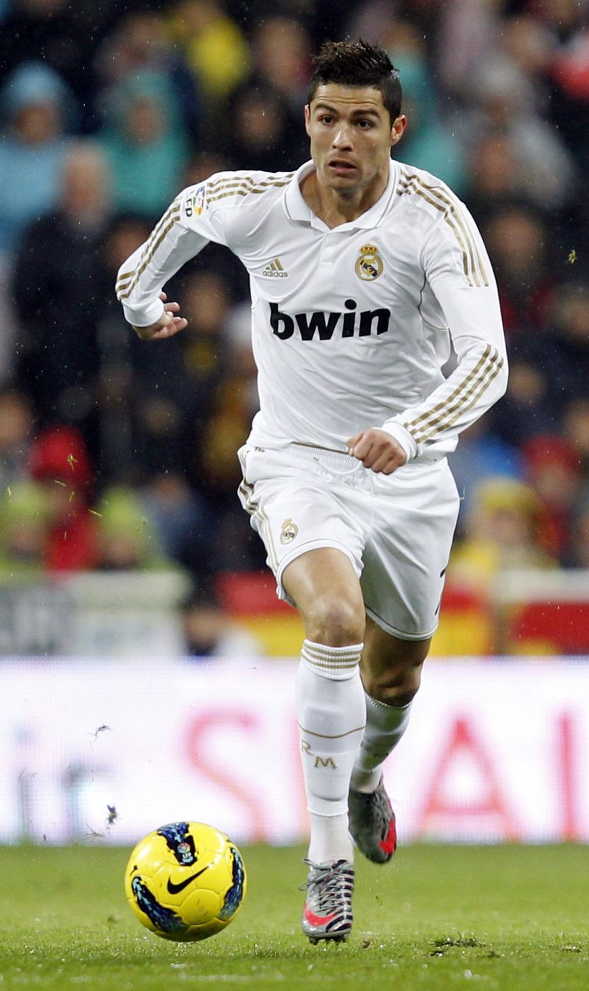 Real Madrid's Cristiano Ronaldo runs with the ball during their Spanish first division soccer match, the "Clasico", against Barcelona at the Santiago Bernabeu stadium in Madrid