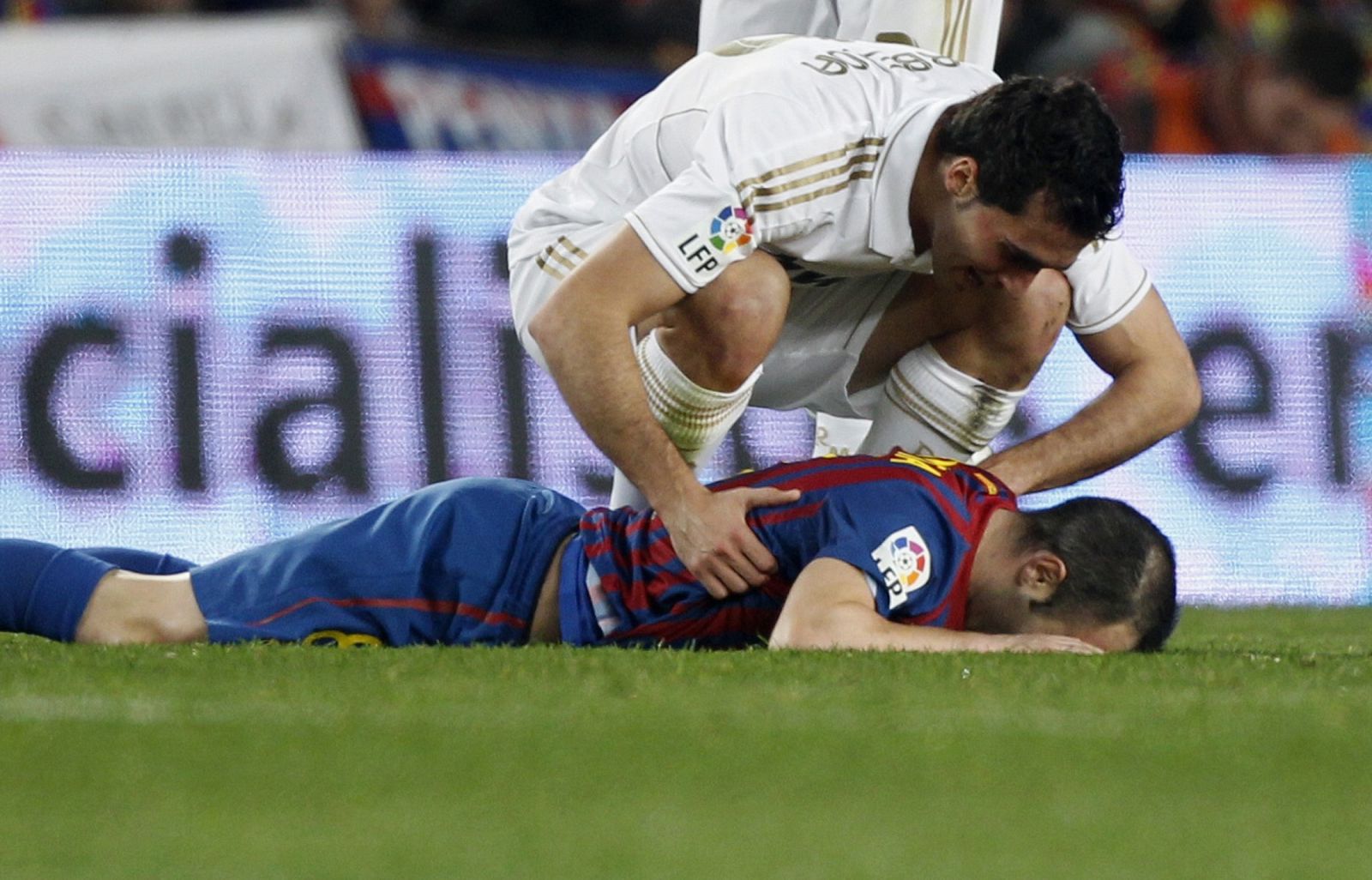 Real Madrid's Arbeloa speaks to Barcelona's Iniesta after being injured during their Spanish King's Cup quarter-final soccer match in Barcelona