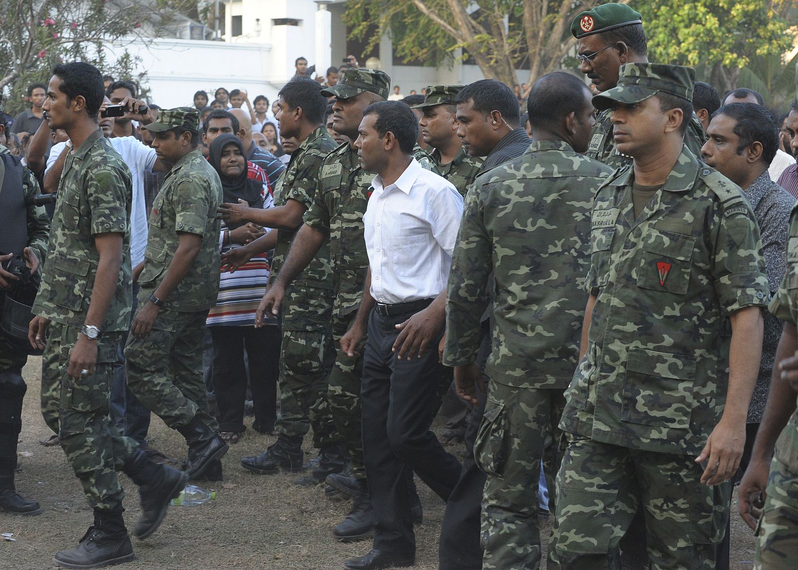 El presidente de Maldivas, Mohamed Nashid (en el centro, con camisa blanca) en el cuartel del Ejército tras entrevistarse con la Policía