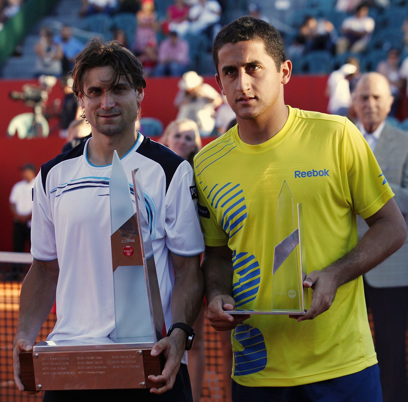 Ferrer of Spain and compatriot Almagro pose with their trophies after their men's singles final tennis match at ATP Buenos Aires Open