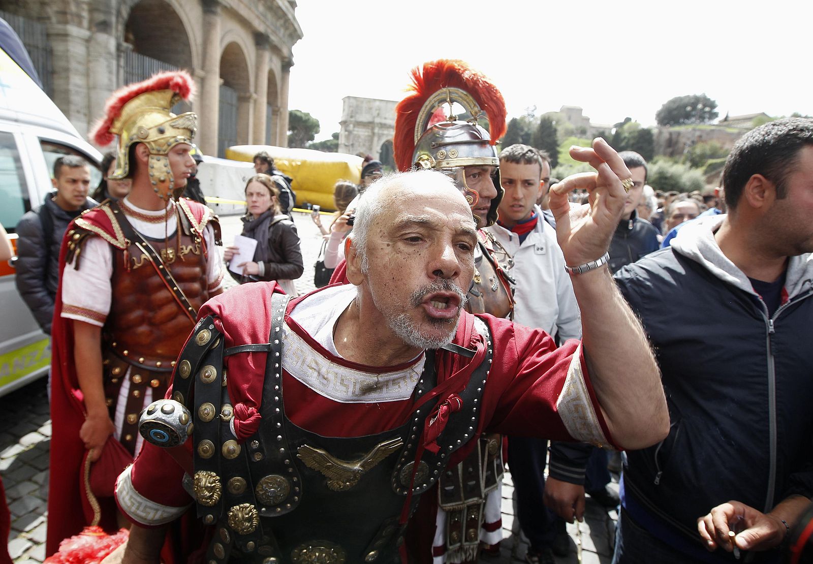 A man dressed as an ancient Roman centurion shouts slogan during a protest in front of the Colosseum in Rome