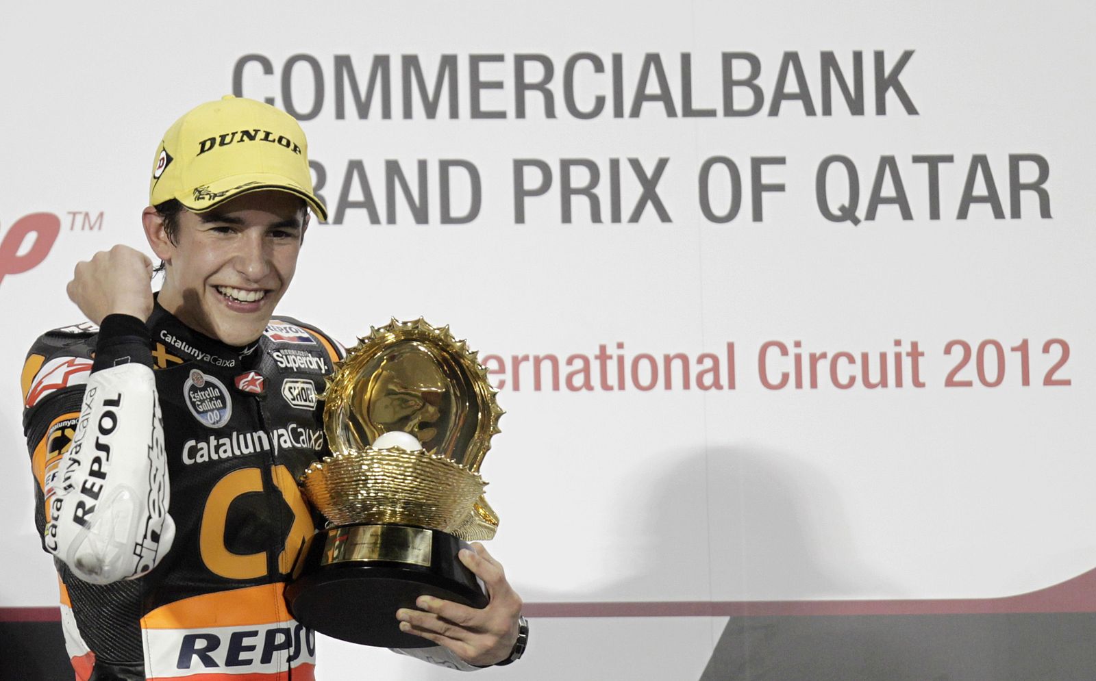 Suter Moto2 rider Marquez of Spain gestures with trophy after winning Moto2 race at Qatar MotoGP Grand Prix at Losail International Circuit in Doha