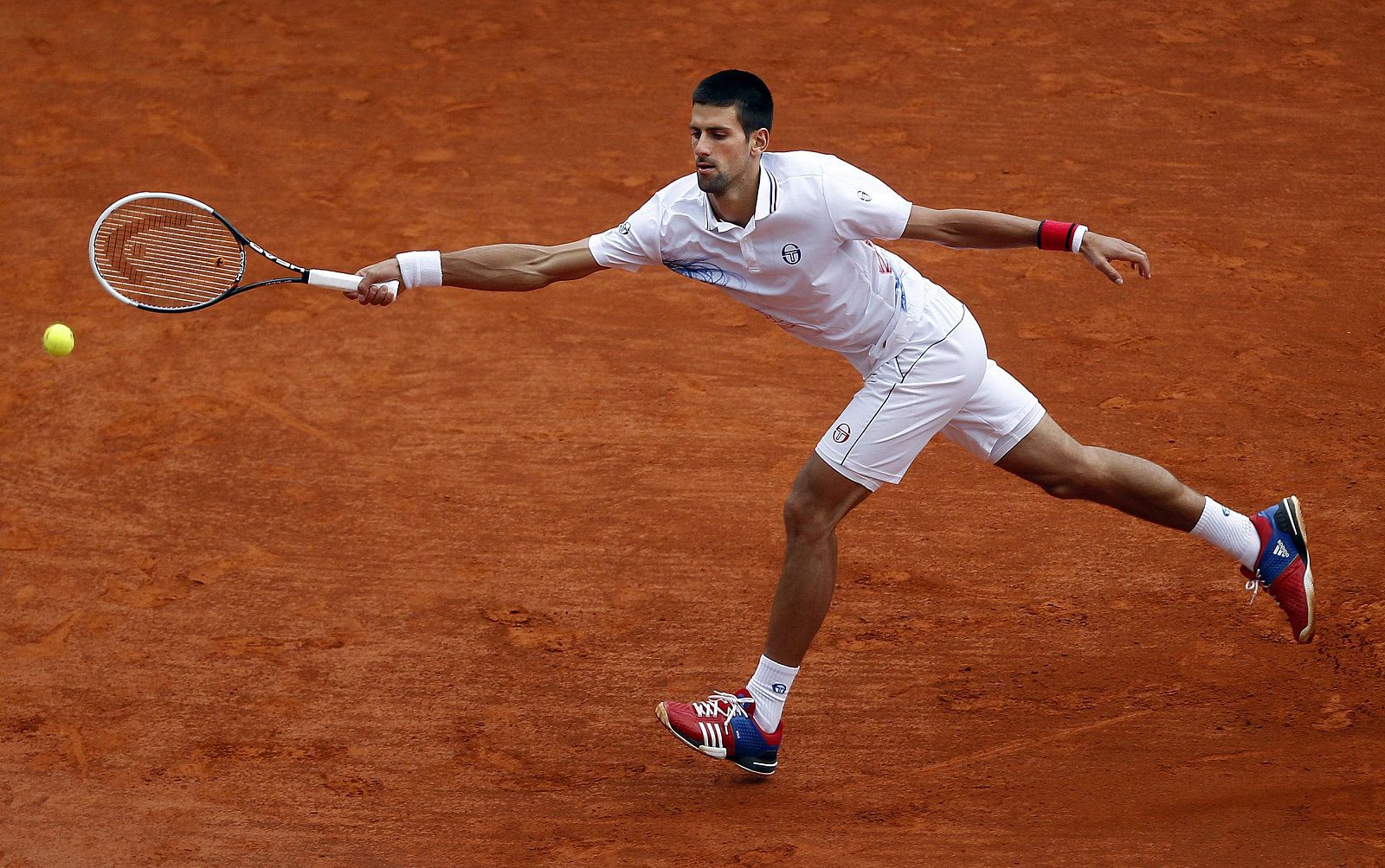 Djokovic of Serbia returns the ball to Dolgopolov of Ukraine during the Monte Carlo Masters in Monaco