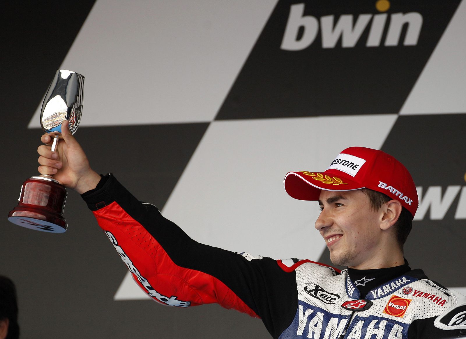 Yamaha MotoGP rider Lorenzo of Spain holds up trophy on podium of the Spanish Grand Prix in Jerez de la Frontera