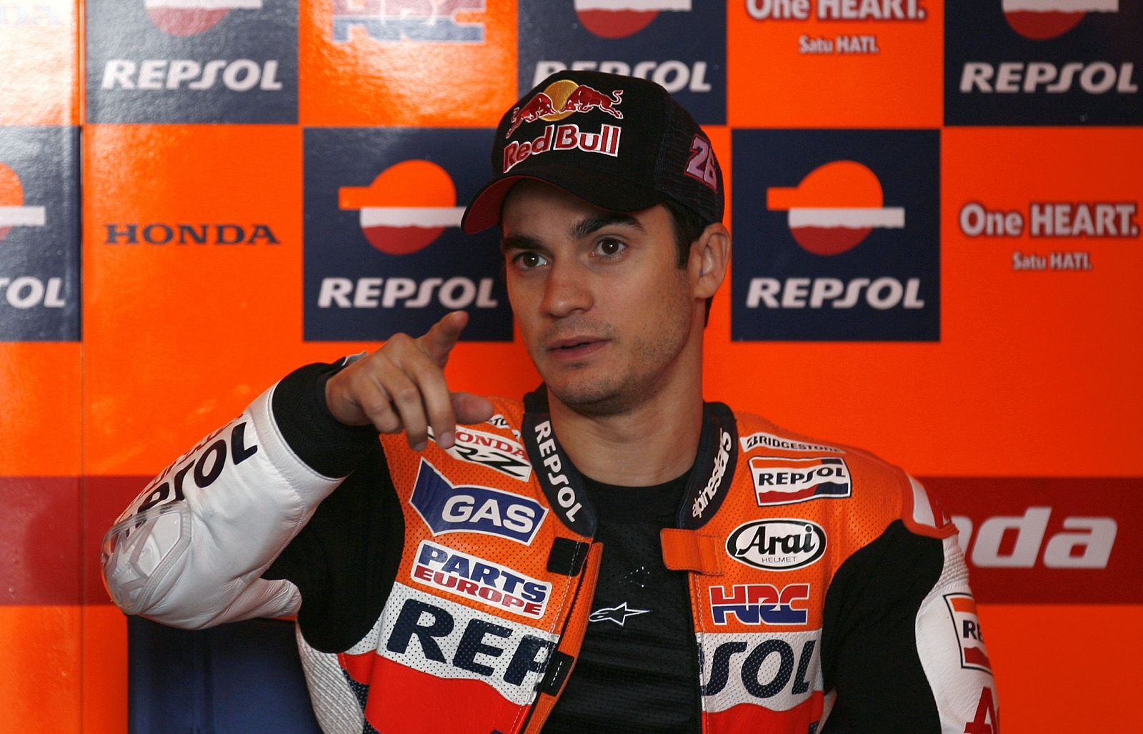 Honda MotoGP rider Dani Pedrosa of Spain speaks with members of his team in his garage during the first free practice session at the Portuguese Grand Prix in Estoril