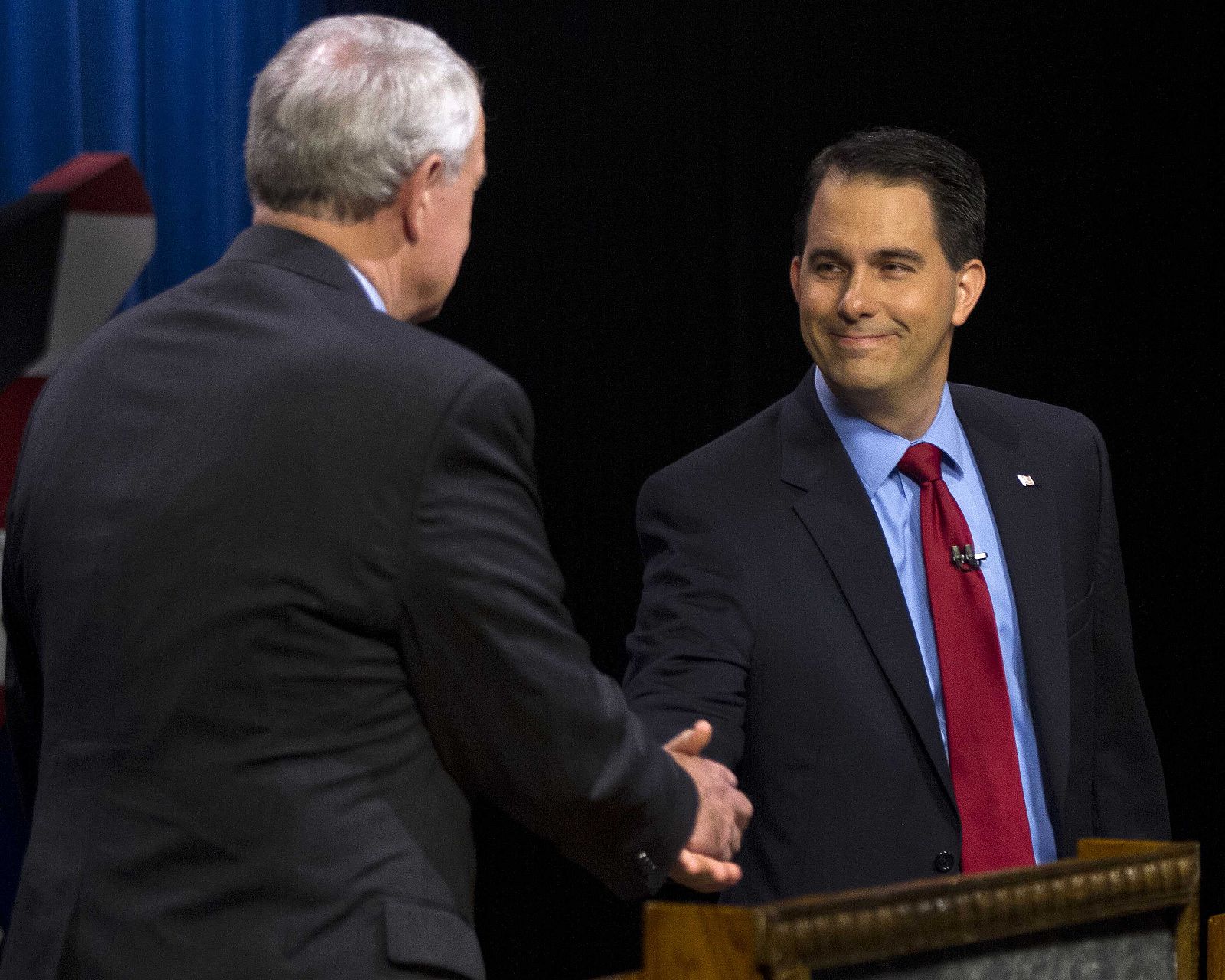 Republican Wisconsin Governor Scott Walker, who is facing a recall election, greets democratic challenger and Milwaukee Mayor Tom Barrett before the start of the debate in Milwaukee
