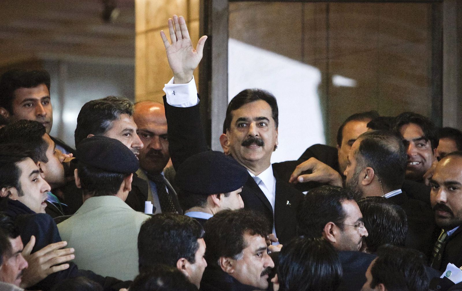 File photo of Pakistan's PM Gilani waving after arriving at the Supreme Court in Islamabad