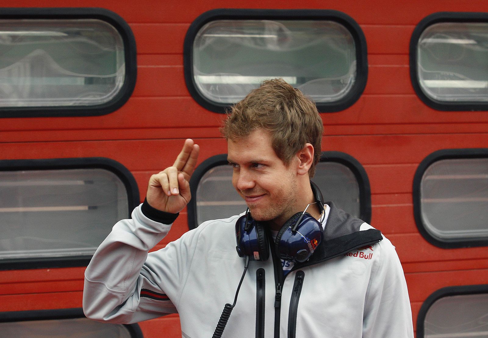 Red Bull Racing Formula One driver Vettel of Germany gestures as he arrives for an official F1 test session at the Mugello race track