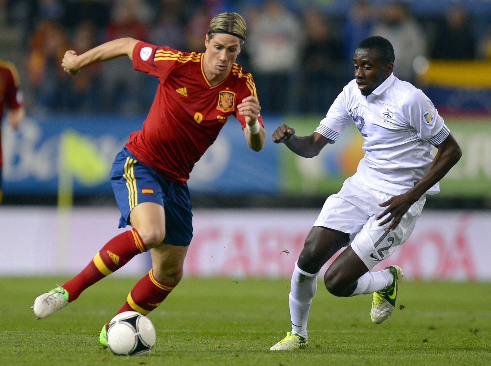 Spain's Fernando Torres challenges France's Blaise Matuidi during their 2014 World Cup qualifying soccer match at Vicente Calderon stadium in Madrid,
