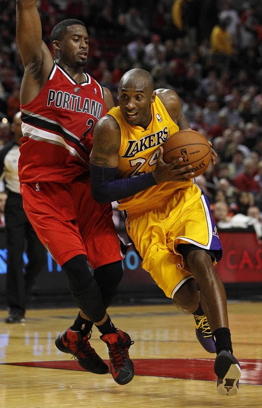 Los Angeles Lakers shooting guard Bryant drives on Portland Trail Blazers shooting guard Matthews during the third quarter of their NBA basketball game in Portland, Oregon