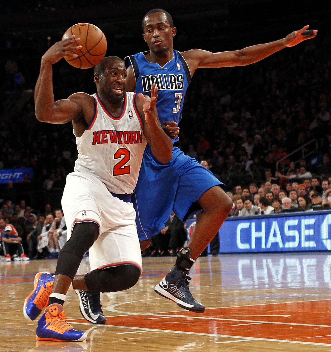 Raymond Felton drives to the basket defended by Dallas Mavericks point guard Rodrigue Beaubois in the third quarter of their NBA basketball game at Madison Square Garden in New York