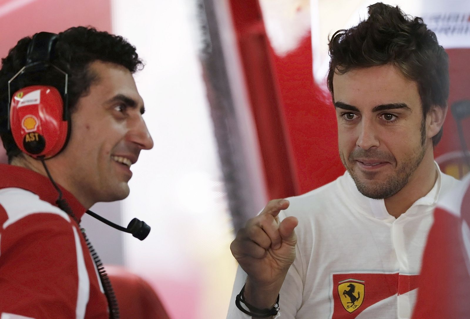 Ferrari Formula One driver Alonso talks with a mechanic in the garage before the start of the first free practice session of the Brazilian F1 Grand Prix at Interlagos circuit in Sao Paul