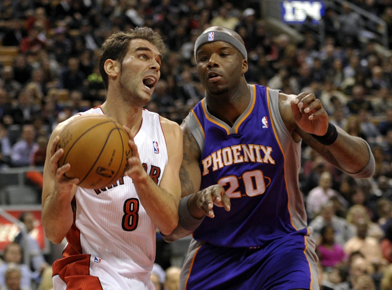 Raptors Calderon goes to the basket against Suns O'Neal during their NBA basketball game in Toronto