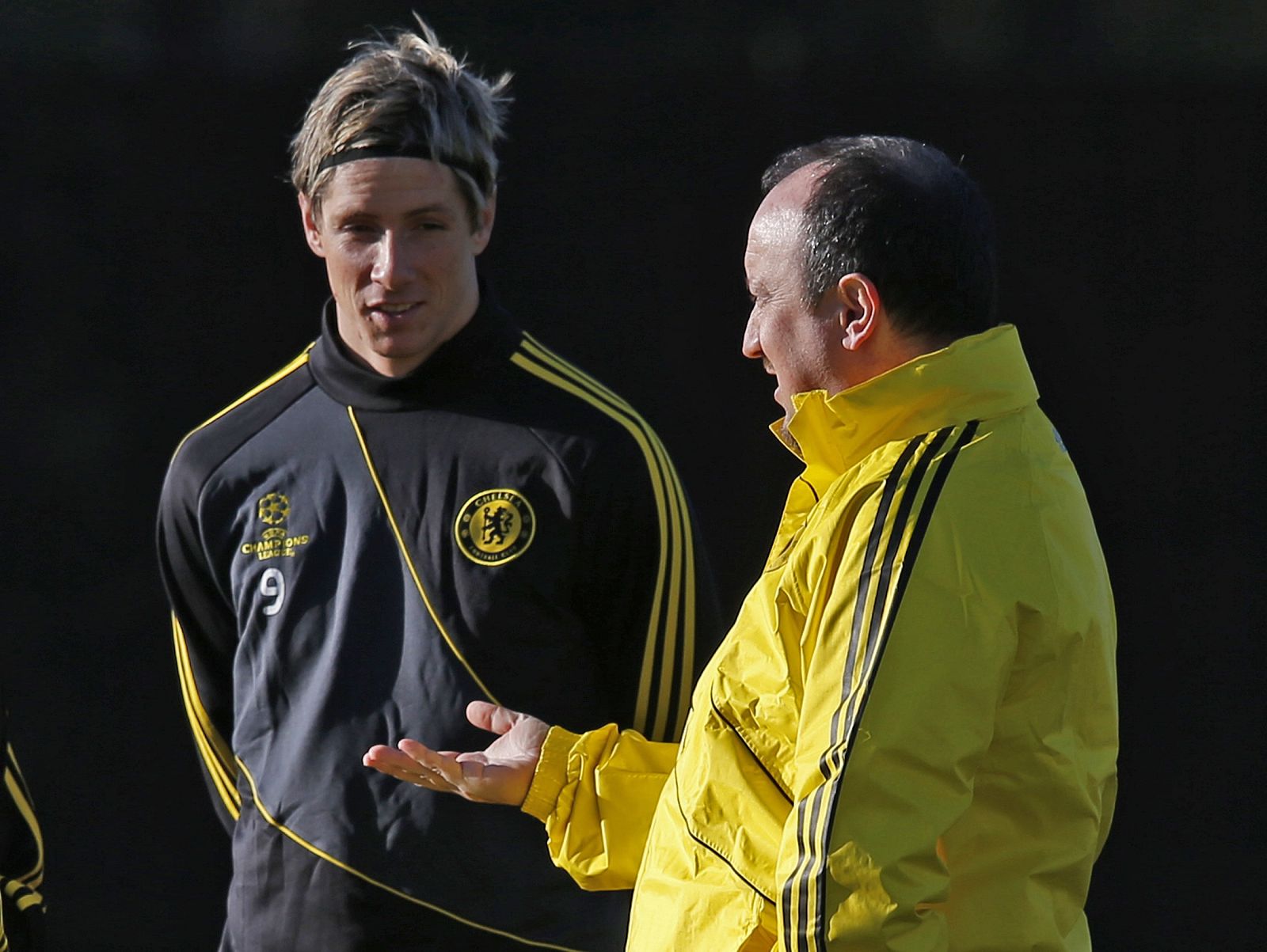 Chelsea's interim head coach Benitez talks to Torres during a team training session at their training ground in Cobham