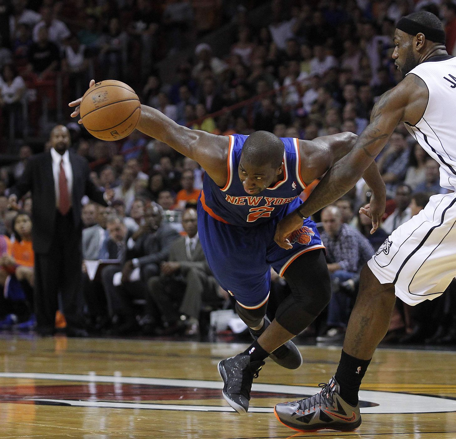 New York Knicks' Raymond Felton moves around Miami Heat's LeBron James in Florida