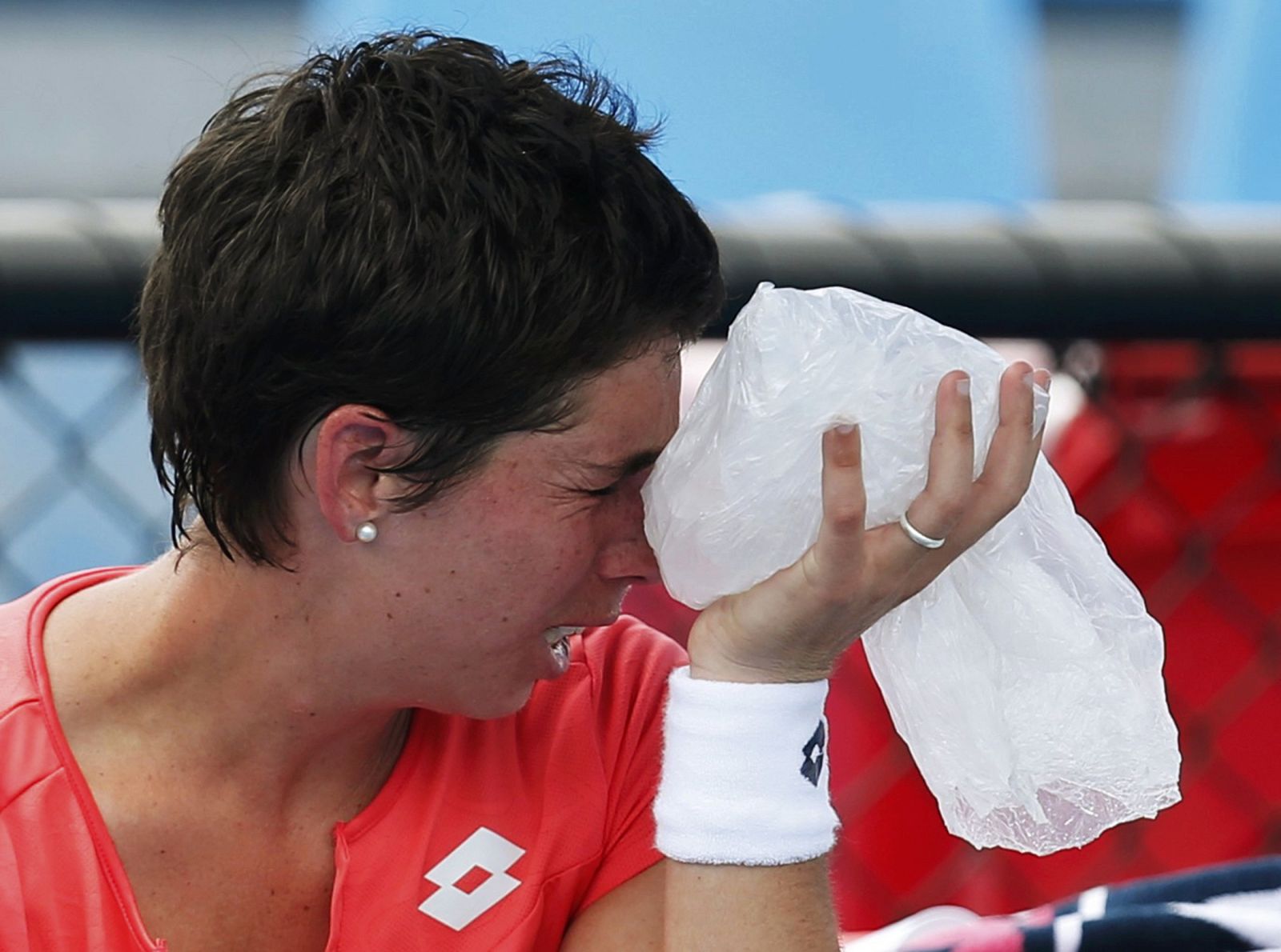 Carla Suarez Navarro of Spain cools down with an ice pack during her women's singles match against Yulia Putintseva of Kazakhstan at the Australian Open tennis tournament in Melbourne