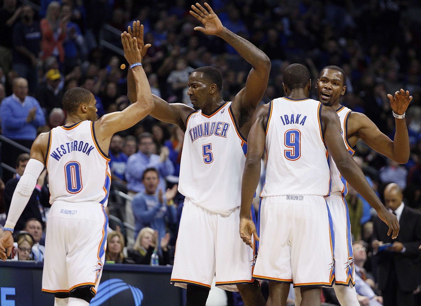 Oklahoma City Thunder starters Russell Westbrook, Kendrick Perkins), Serge Ibaka and Kevin Durant celebrate their play during a timeout against Denver Nuggets in their NBA basketball game in Oklahoma City