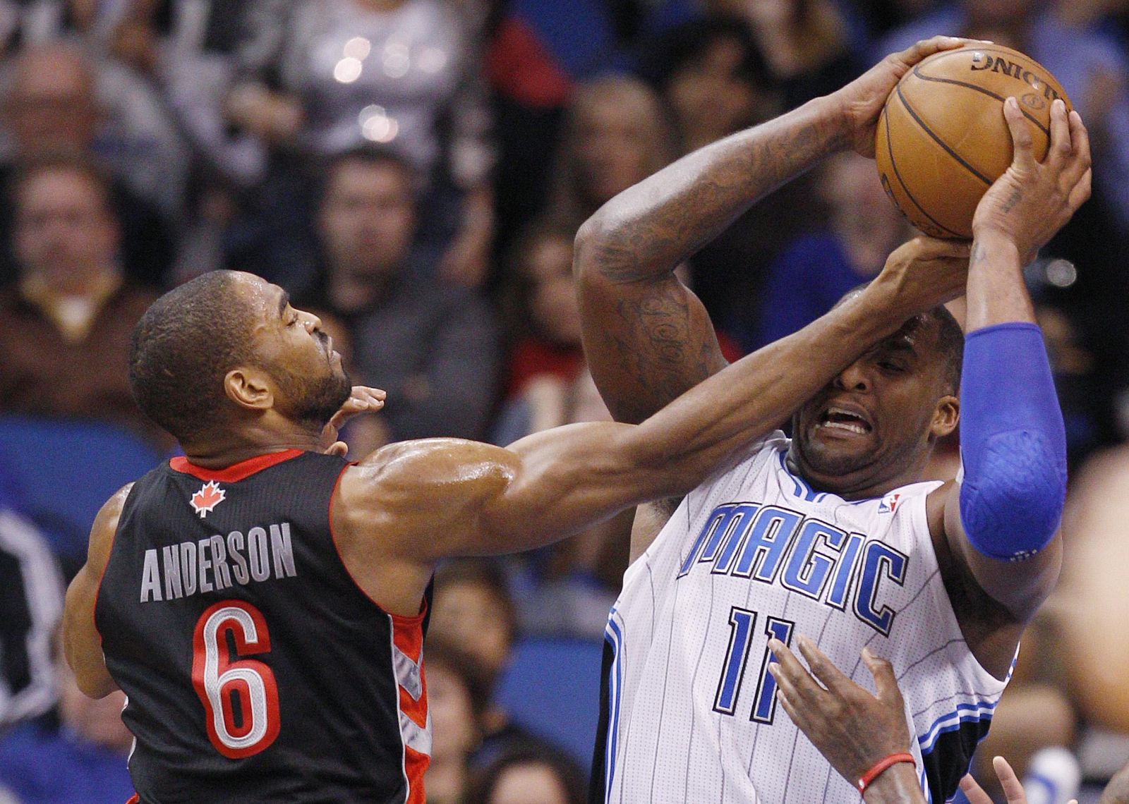 Orlando Magic forward Glen Davis battles for the ball with Toronto Raptors forward Alan Anderson during the second half of their NBA basketball game in Orlando