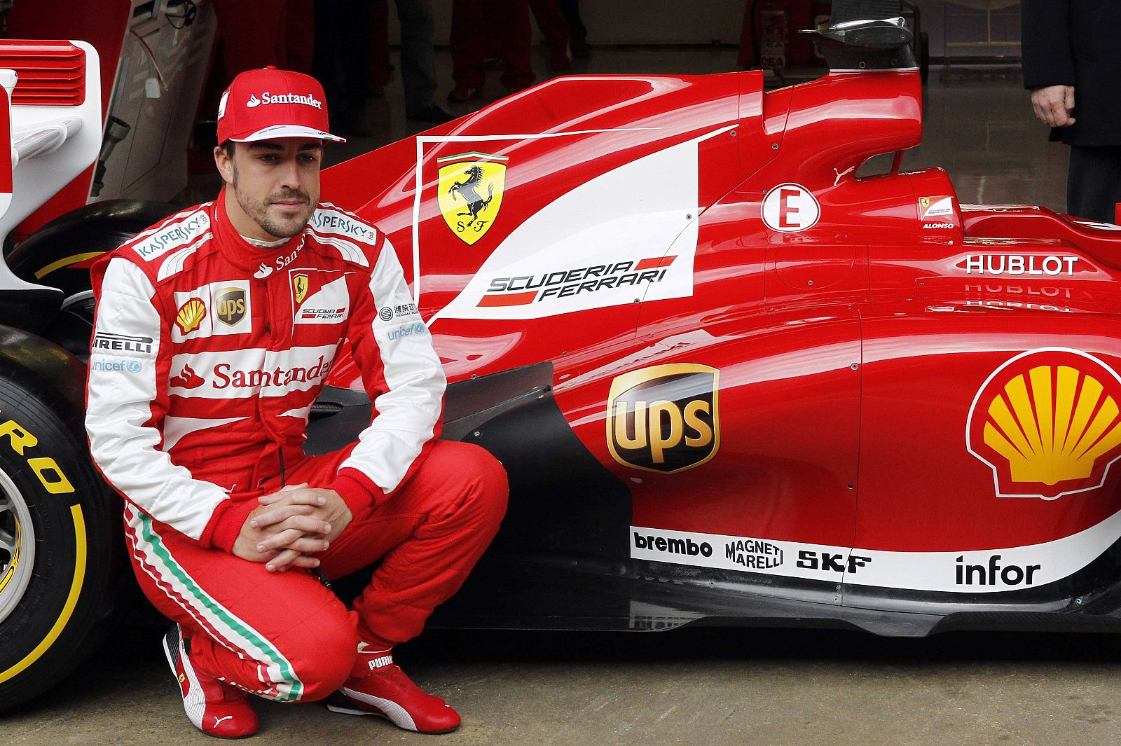 Ferrari's Formula One driver Fernando Alonso of Spain poses in front of the new Ferrari F138 racing car during a training session at Circuit de Catalunya racetrack in Montmelo