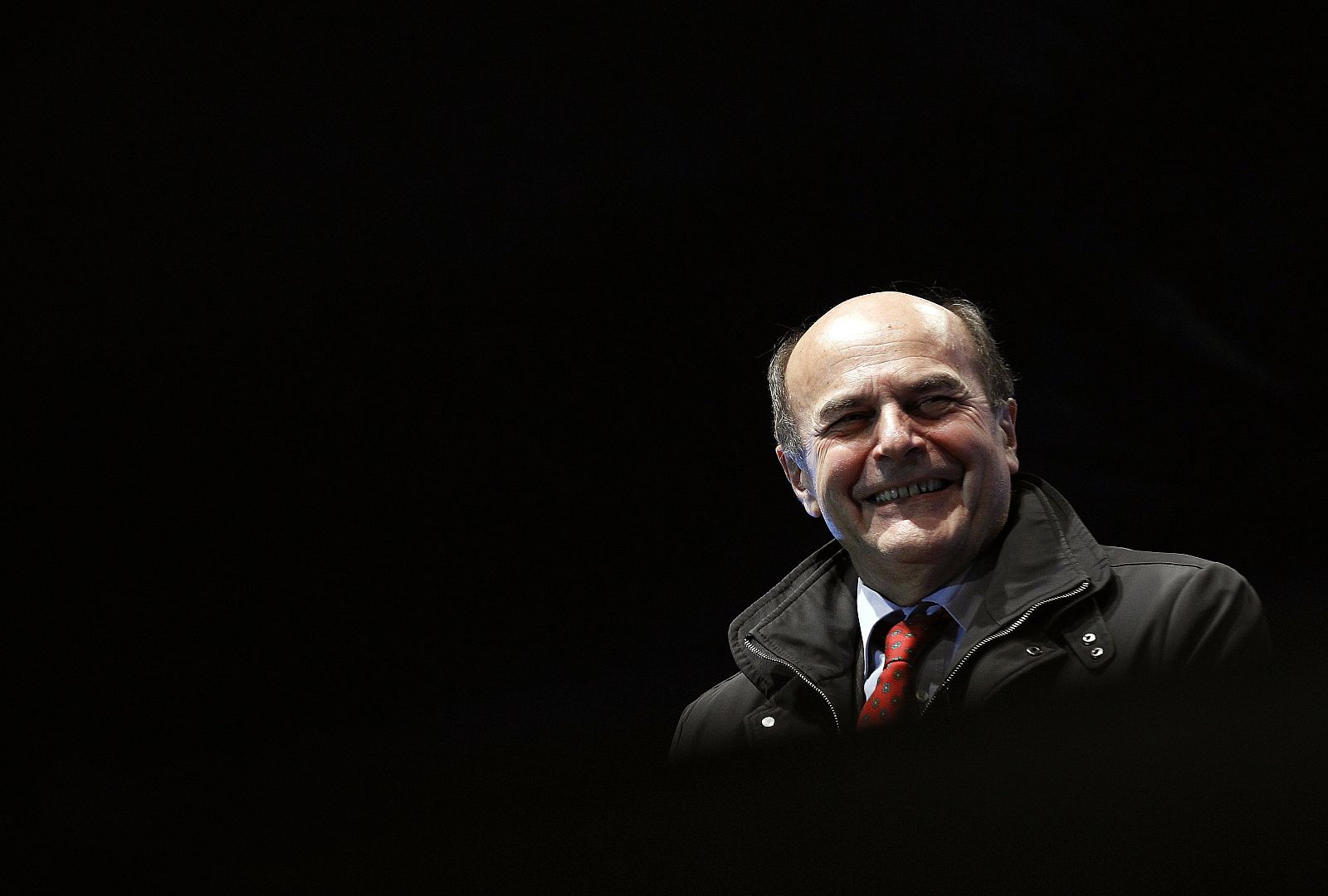 Italy's Democratic Party leader Bersani smiles as he arrives during his political rally in downtown Naples