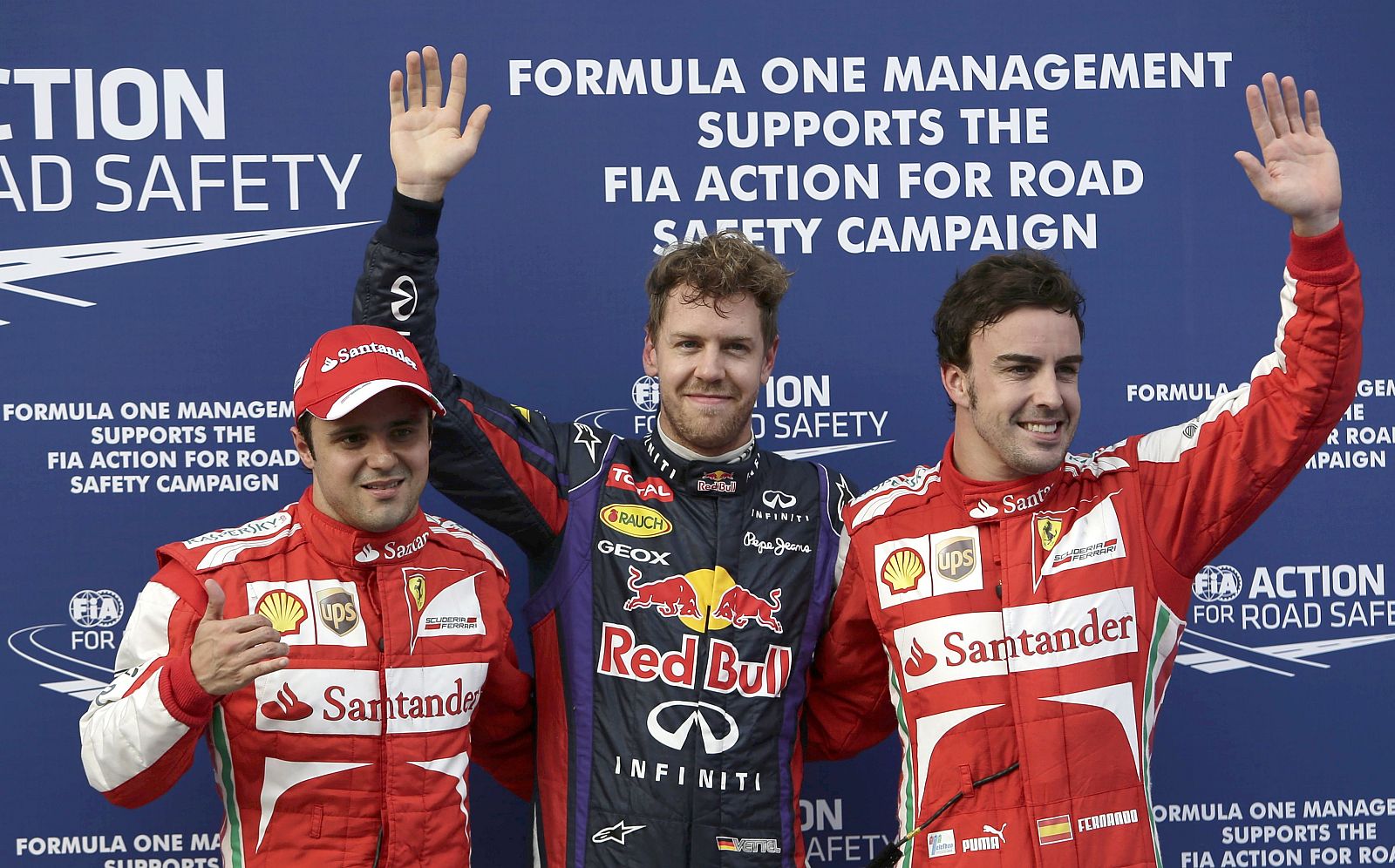 Red Bull Formula One driver Vettel, flanked by Ferrari Formula One drivers Massa and Alonso, pose after the qualifying session for the Malaysian F1 Grand Prix at Sepang International Circuit outside Kuala Lumpur