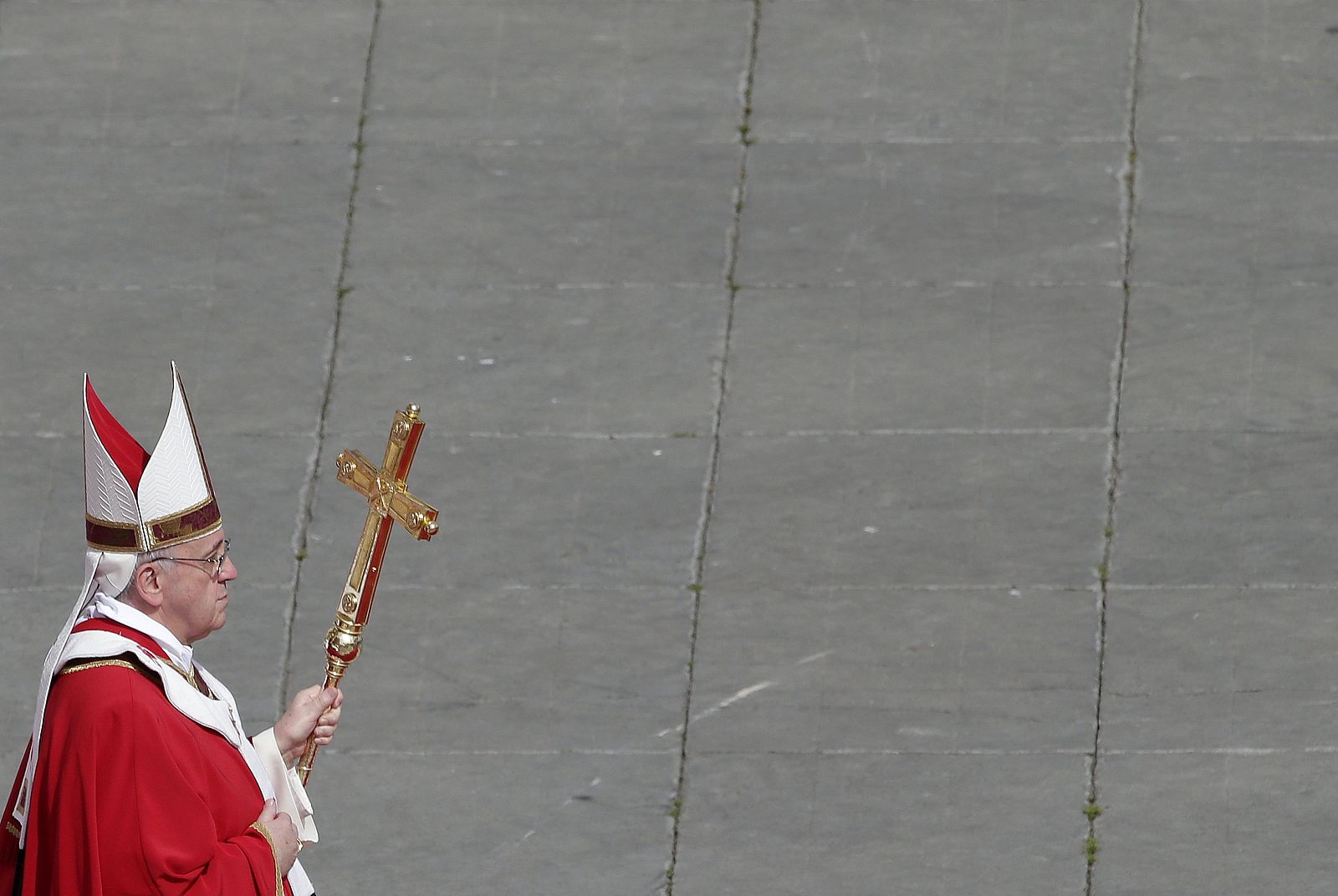 Pope Francis walks with his papal cross during the Palm Sunday mass at Saint Peter's Square at the Vatican