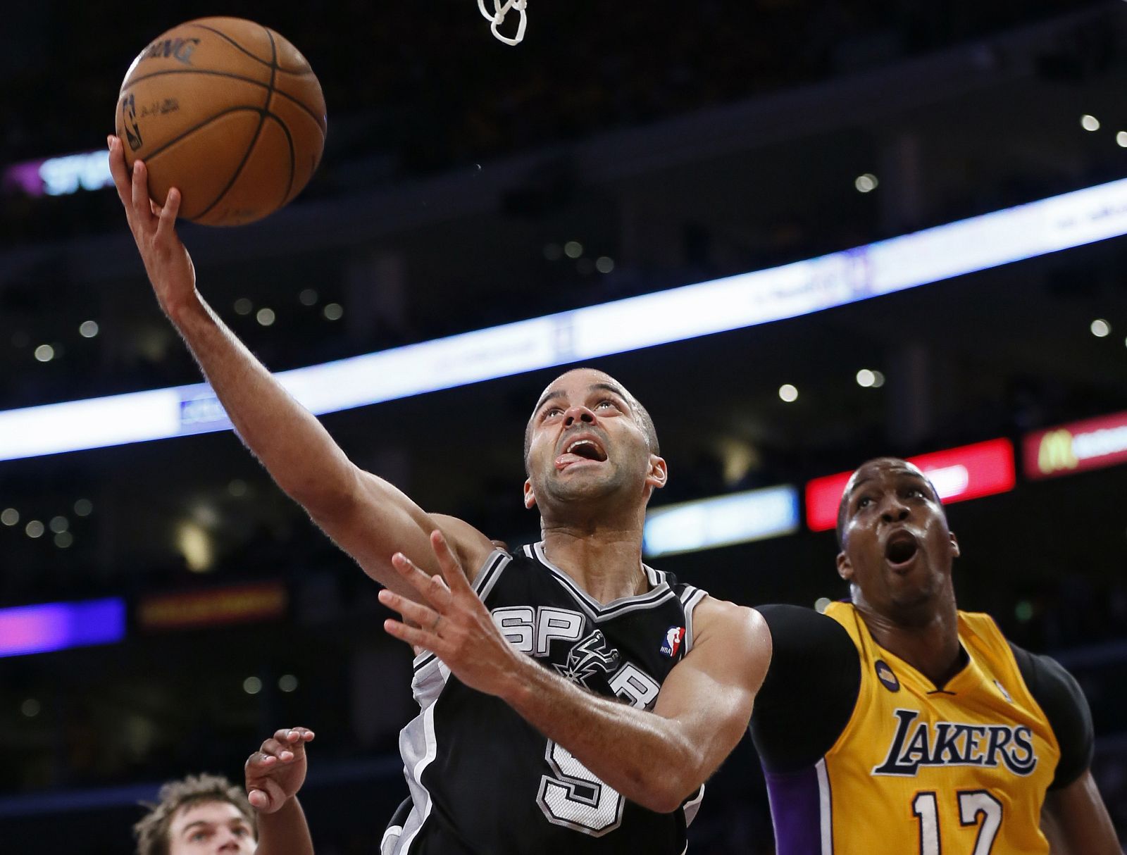 San Antonio Spurs Parker of France is fouled by Los Angeles Lakers Howard as he goes up to shoot during Game 3 of their NBA Western Conference Quarterfinals basketball playoff series in Los Angeles