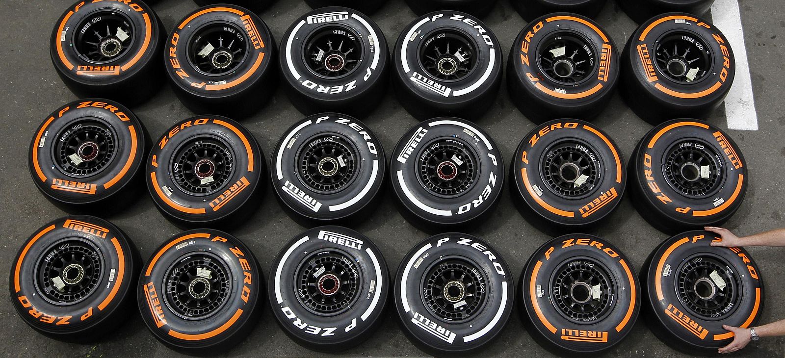 A mechanic arranges Pirelli tyres in the paddock ahead of the Spanish F1 Grand Prix in Montmelo