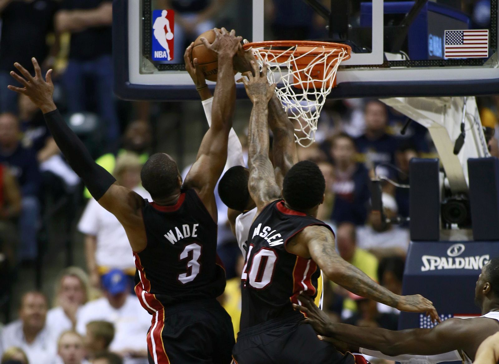 Heat's Wade and Haslem reach up to prevent Pacers' George from scoring in the second half of Game 3 of their NBA Eastern Conference final basketball playoff series in Indianapolis