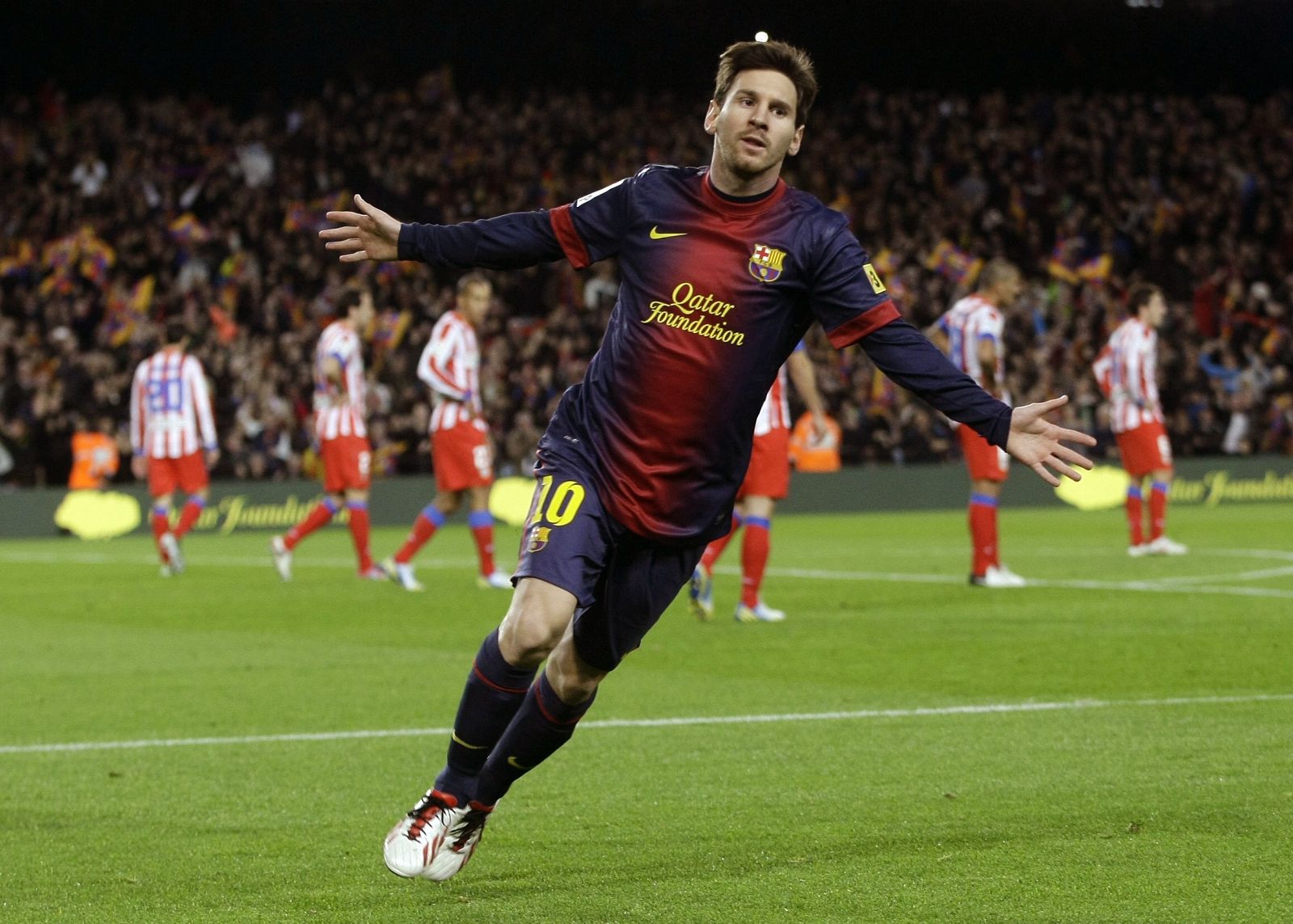 Barcelona's Lionel Messi celebrates his goal against Atletico Madrid during their Spanish first division soccer match at Nou Camp stadium in Barcelona