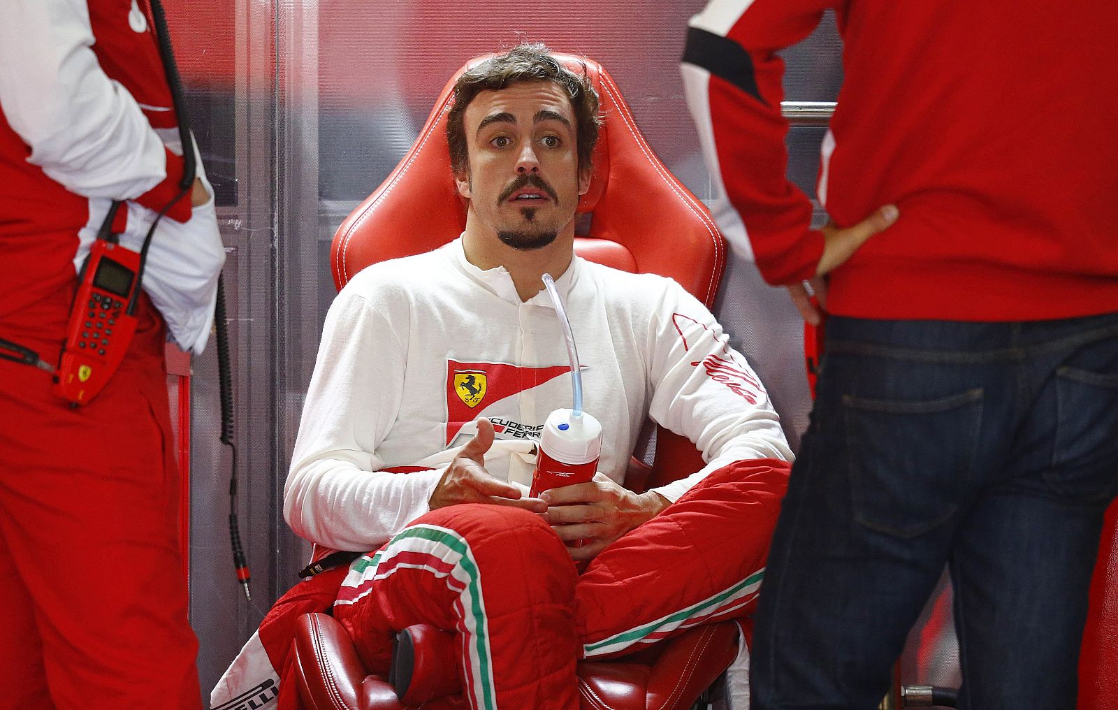 Fernando Alonso sits inside his pit during the first practice session of the German F1 Grand Prix at the Nuerburgring racing circuit