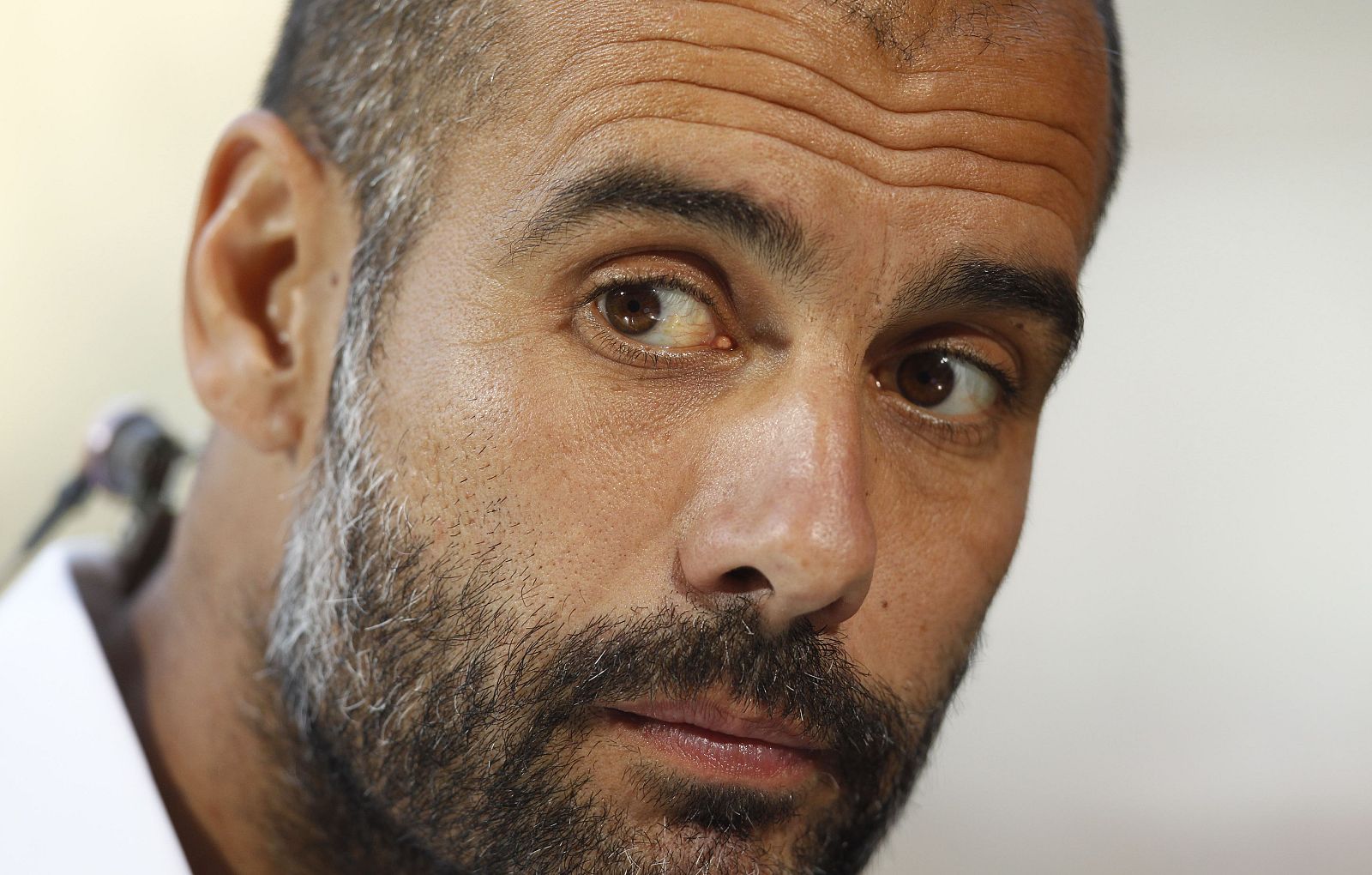 Bayern Munich's coach Guardiola listens during an interview after the Telekom Cup soccer match against Hamburg SV in Moenchengladbach