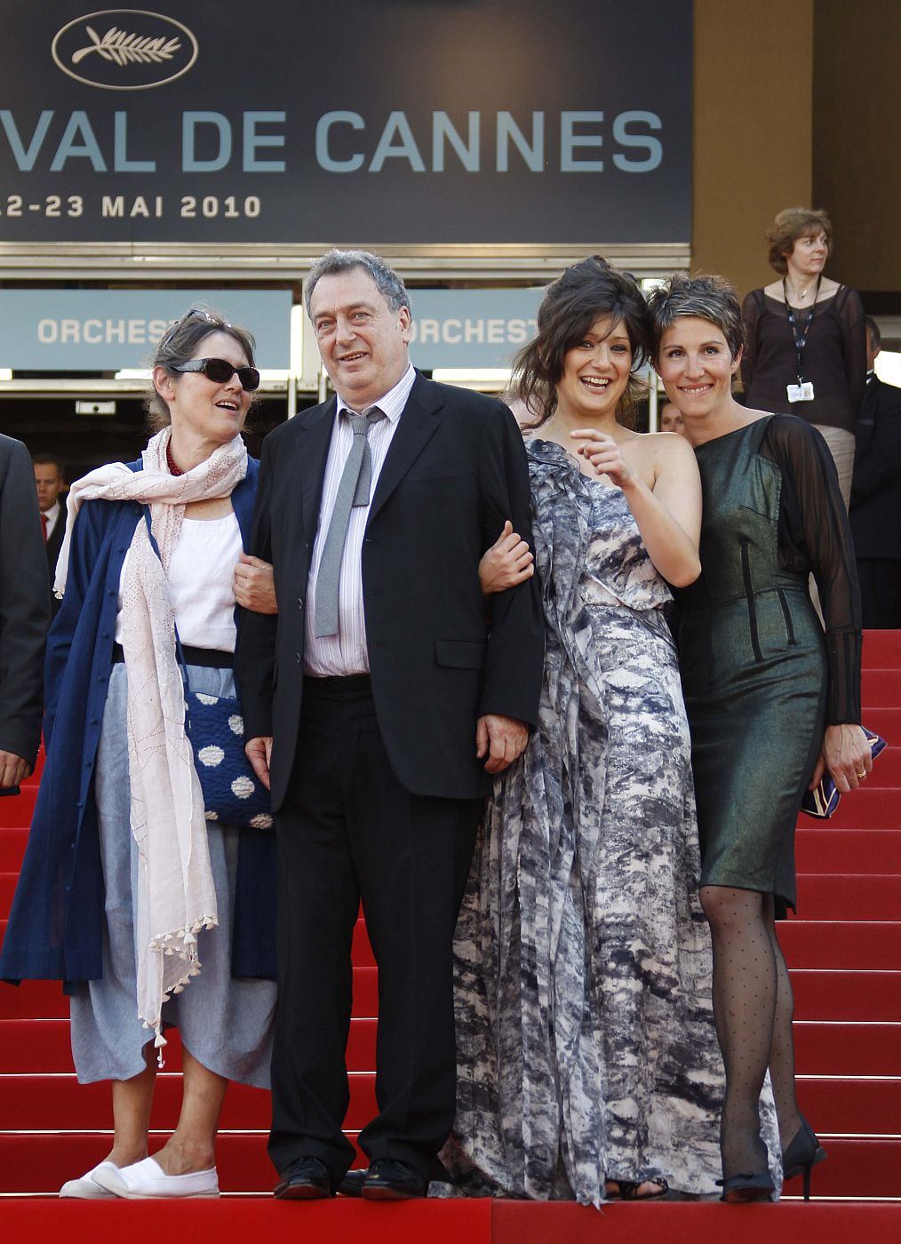 Director Stephen Frears poses with an unidentified women and cast member Tamsin Greig on the red carpet as they arrive at the 63rd Cannes Film Festival