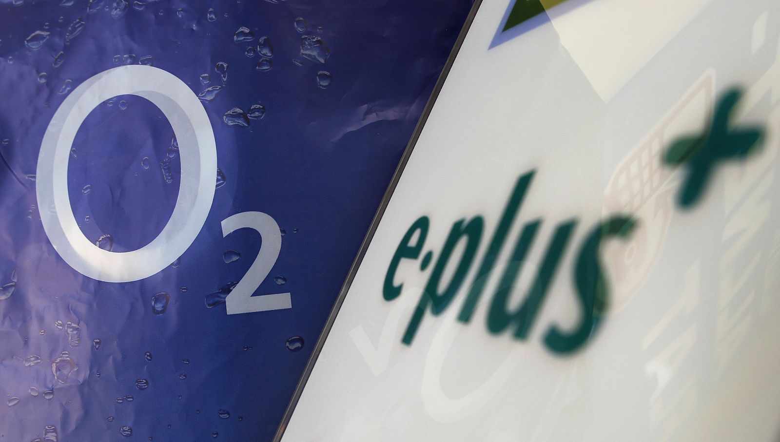 Logo of O2 Deutschland, German daughter of Spain's Telefonica is seen close to E-Plus logo in a store in Germering