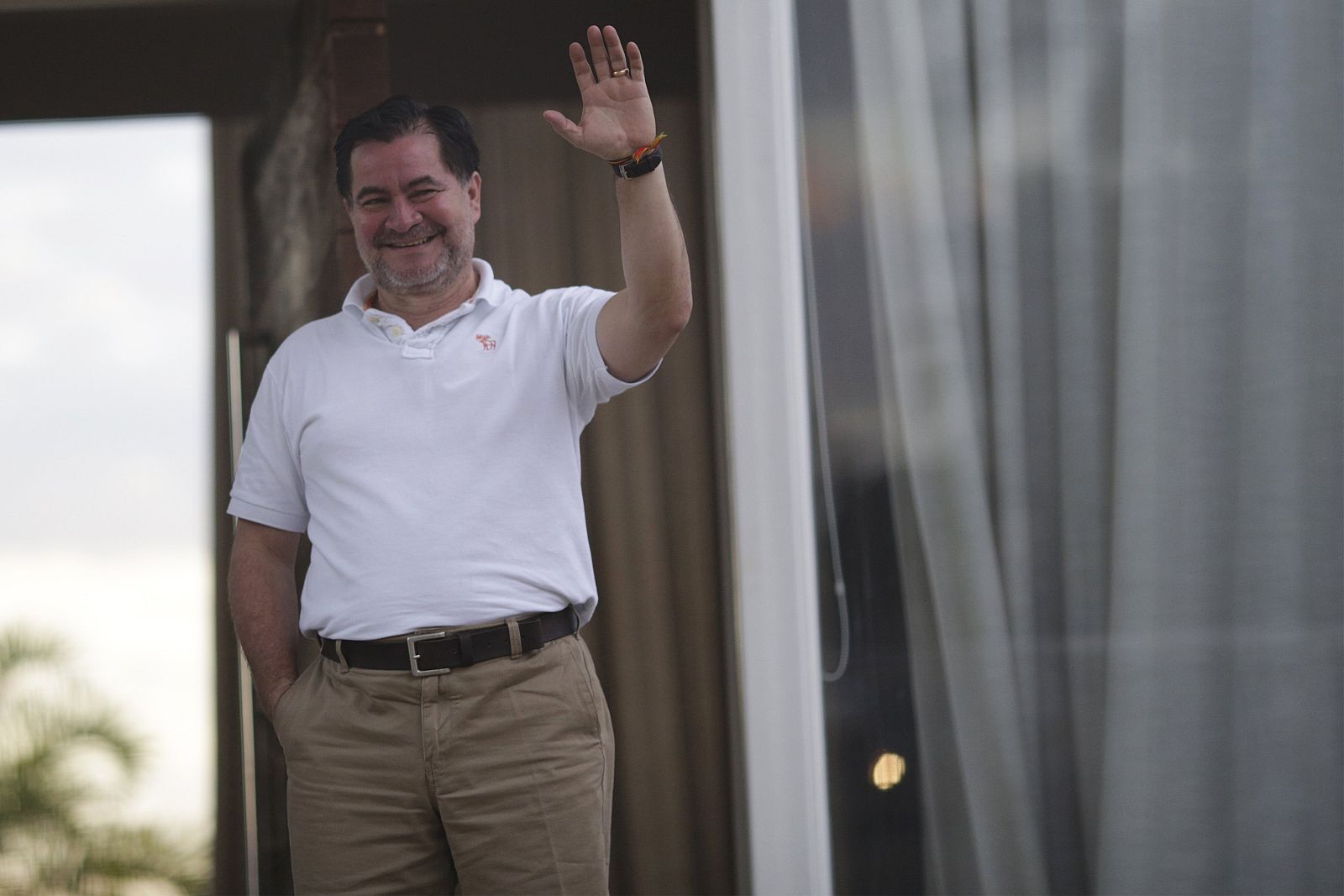 Bolivian Senator Roger Pinto Molina waves from the front door of his Brazilian lawyer Fernando Tiburcio Pena's house, in Brasilia
