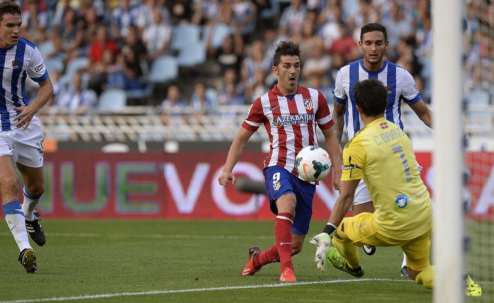 Atletico Madrid's Villa kicks to score against Real Sociedad during their Spanish first division soccer match in San Sebastian